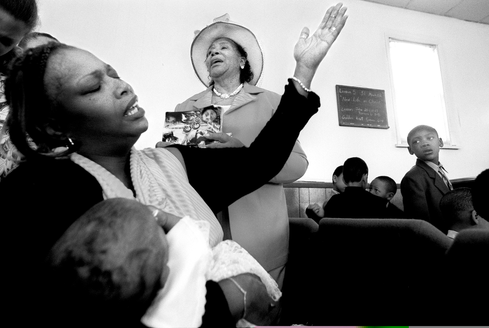  The Miracle Faith Missionary Church in Monroe (MI) is filled with songs of praise as the congregation, including Beverly Chambers, left, and Adealia Turnage, wife of founding pastor Robert D. Turnage, join in the Easter celebration. Ms. Chambers cam