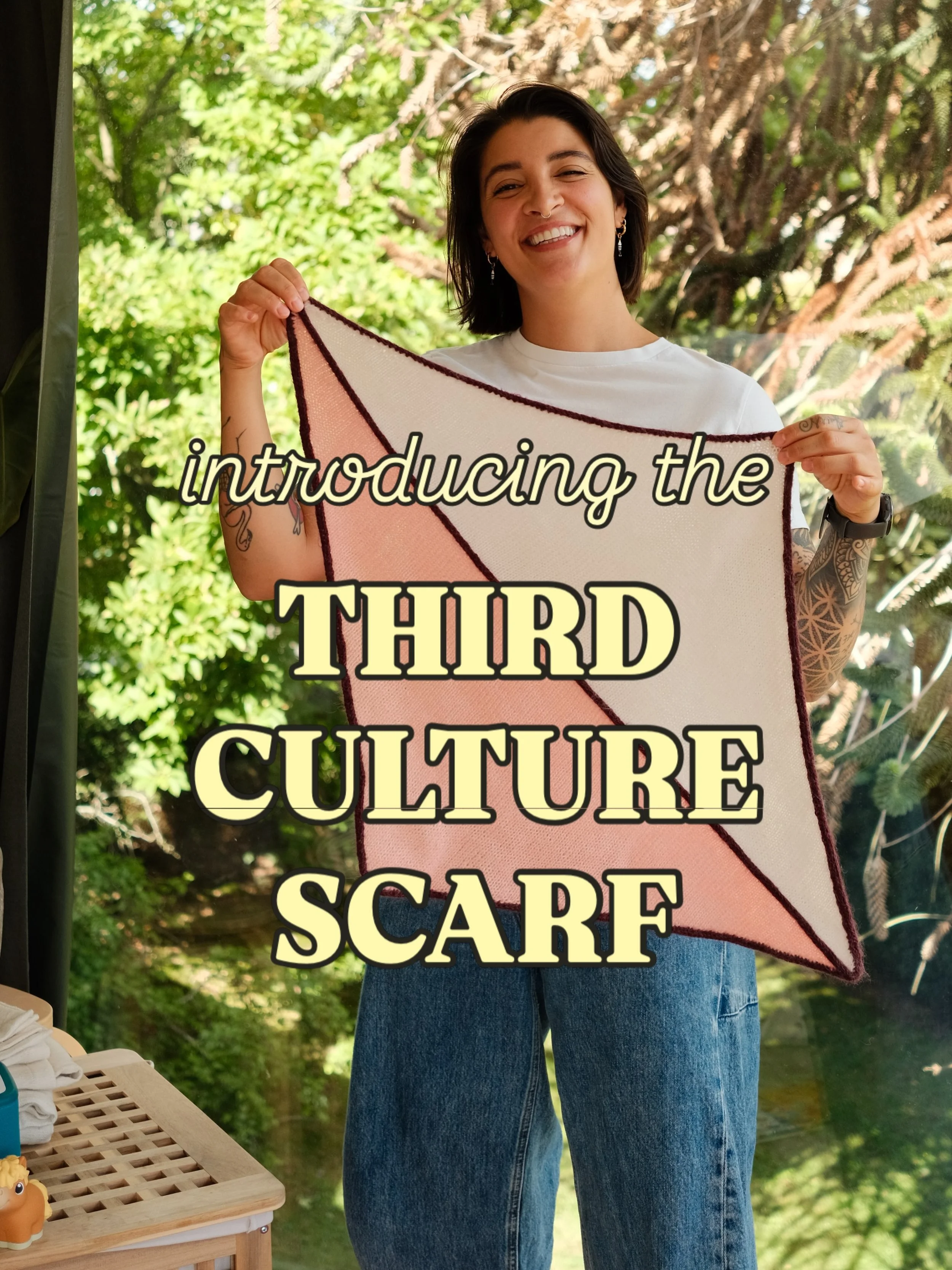I am so excited to introduce you to my very first knitting  pattern, the Third Culture Scarf 🥰
 
The Third Culture Scarf is a FREE gaugeless pattern (you can use any yarn in your stash!) that puts a twist on the usual triangle scarf. It features 2 t