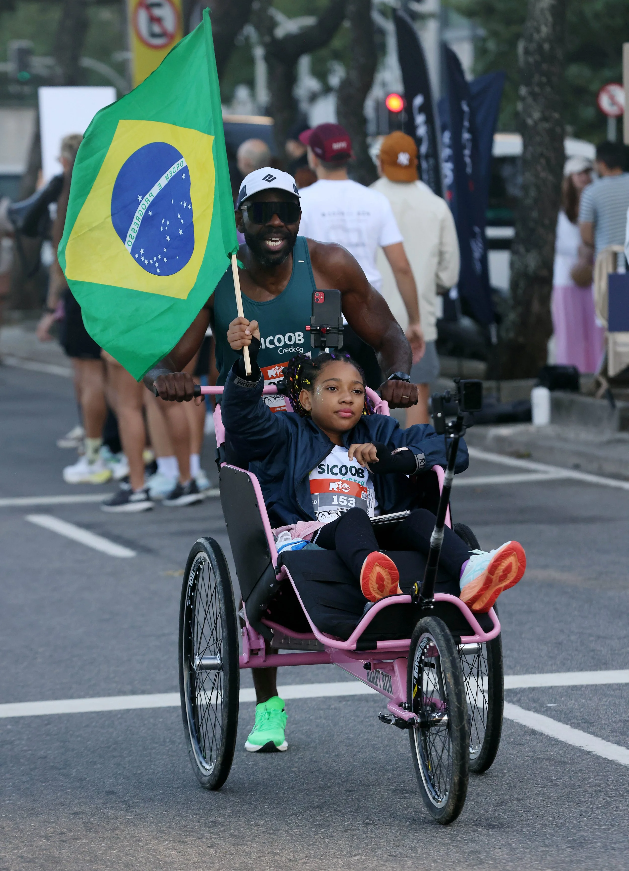 Edvaldo Souza dos Santos and his 10-year-old daughter Sophia during the Rio Marathon.. Sophia has a rare condition that affects her lower limbs but that doesnt stop her from participating