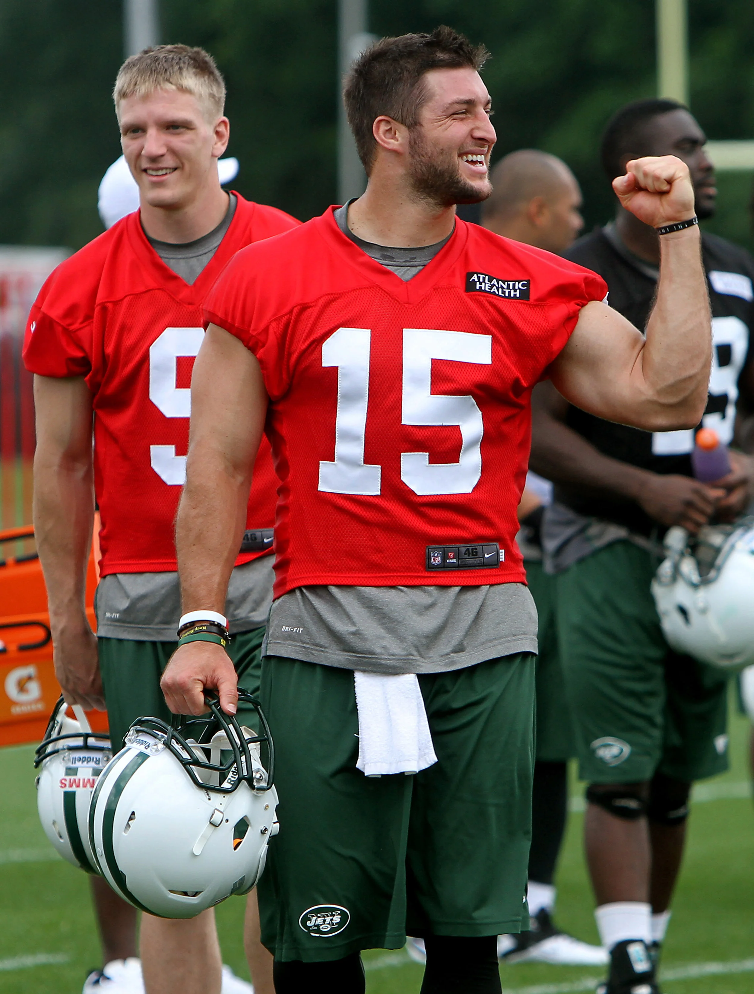 NY Jets quarterback Tim Tebow jokes around as he walks off the field after practice at the Atlantic Health Training Center. Florham Park, NJ