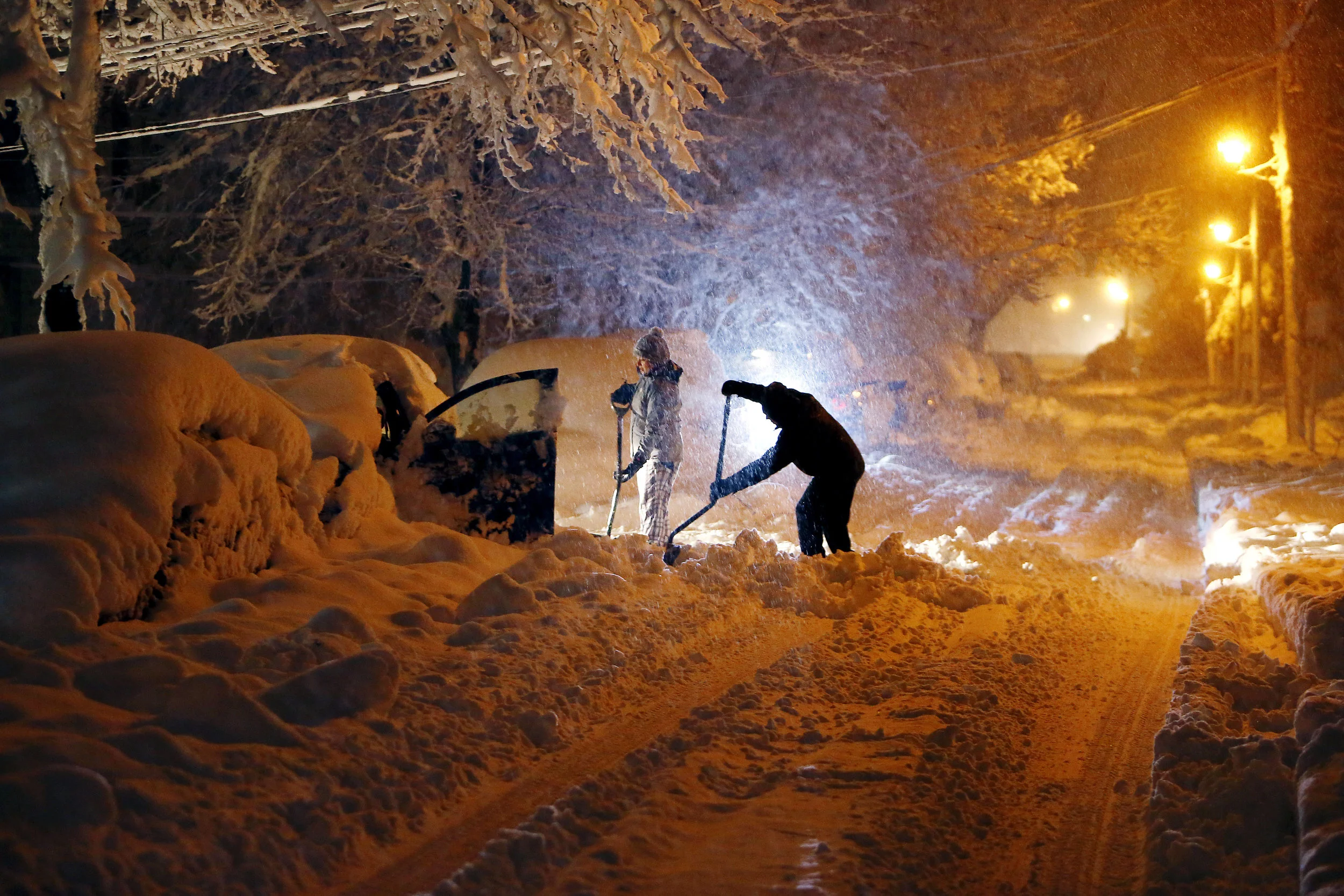 Residents on Mills Street dig out their car after a nor'easter dumped two feet of snow around the area. Morristown, NJ