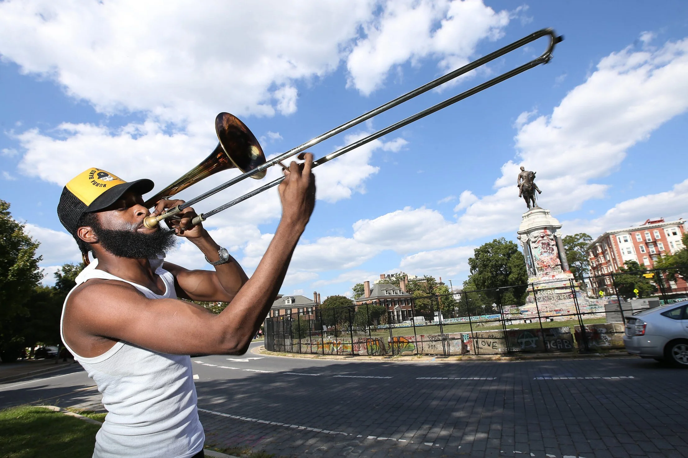Isaiah Robinson plays the blues in front of a statue of Robert E. Lee where he stood as a symbol of white supremacy for 131 years. 