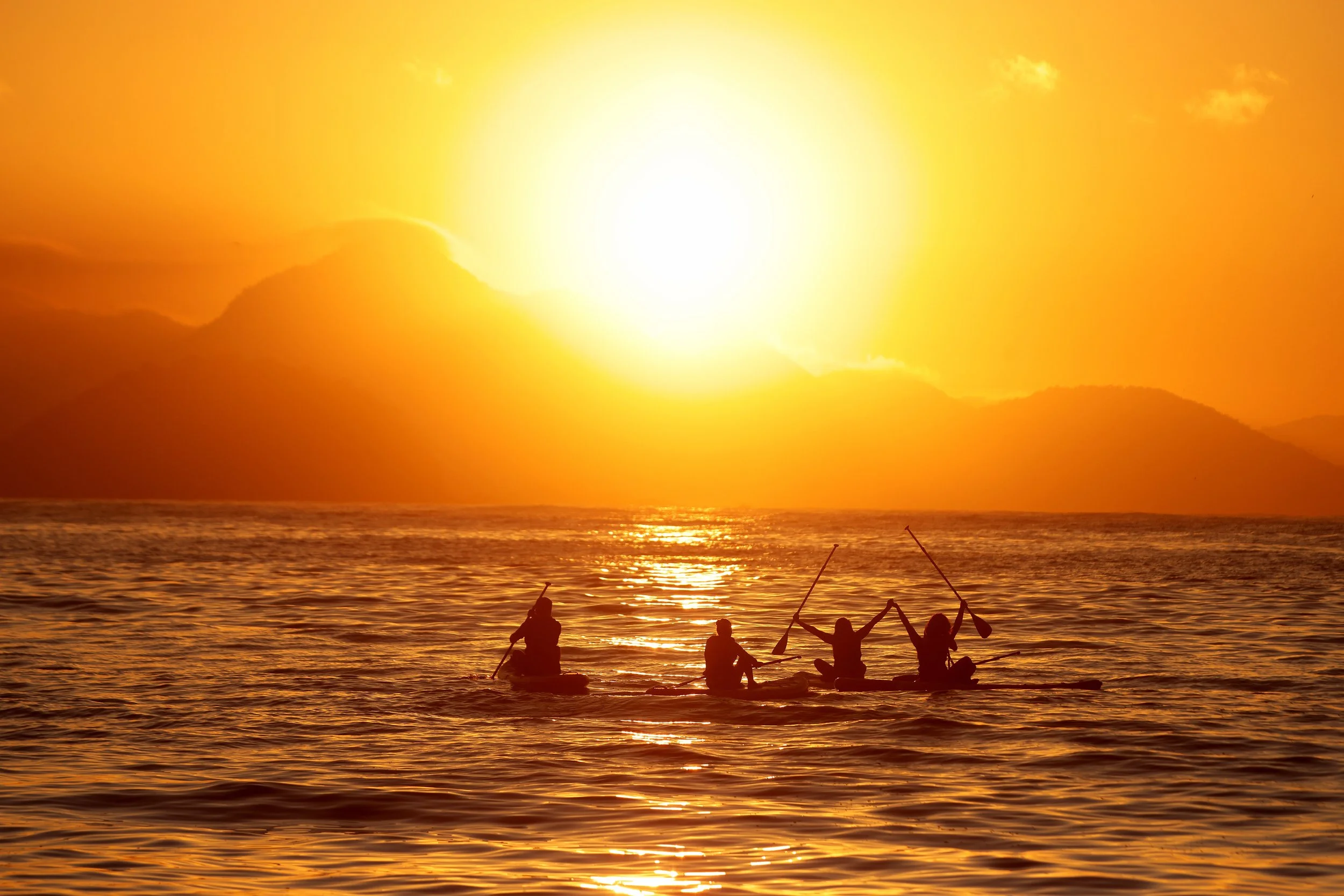Paddleboarders give thanks taking to the water at sunrise as new Stand Up Paddle (SUP) regulations go into effect at 6 a.m. Saturday in Copacabana.