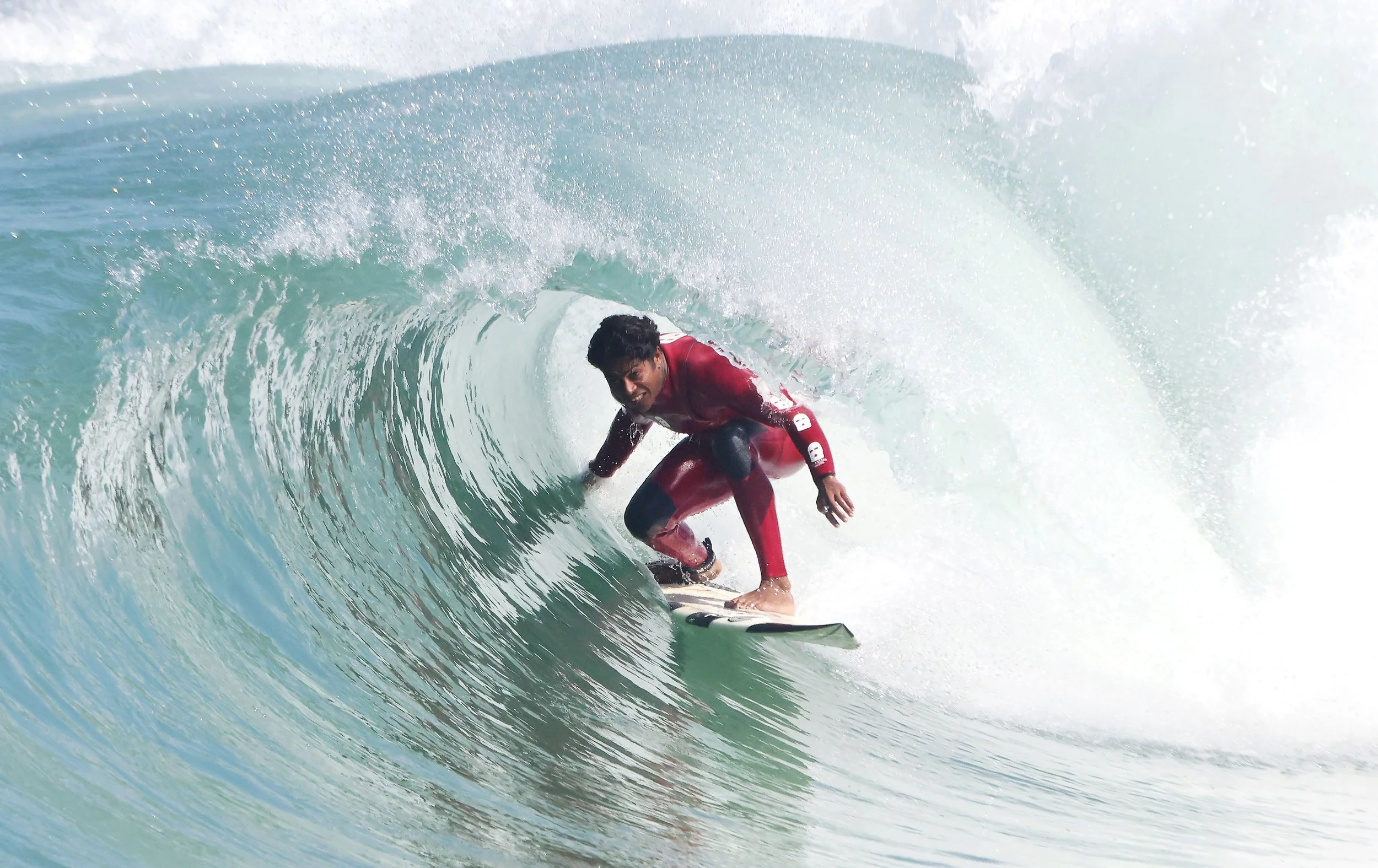 Pro surfer GABRIEL PALMEIRA of Rio de Janeiro deep in the barrel at Arpoador, mastering one of surfing’s most iconic maneuvers.