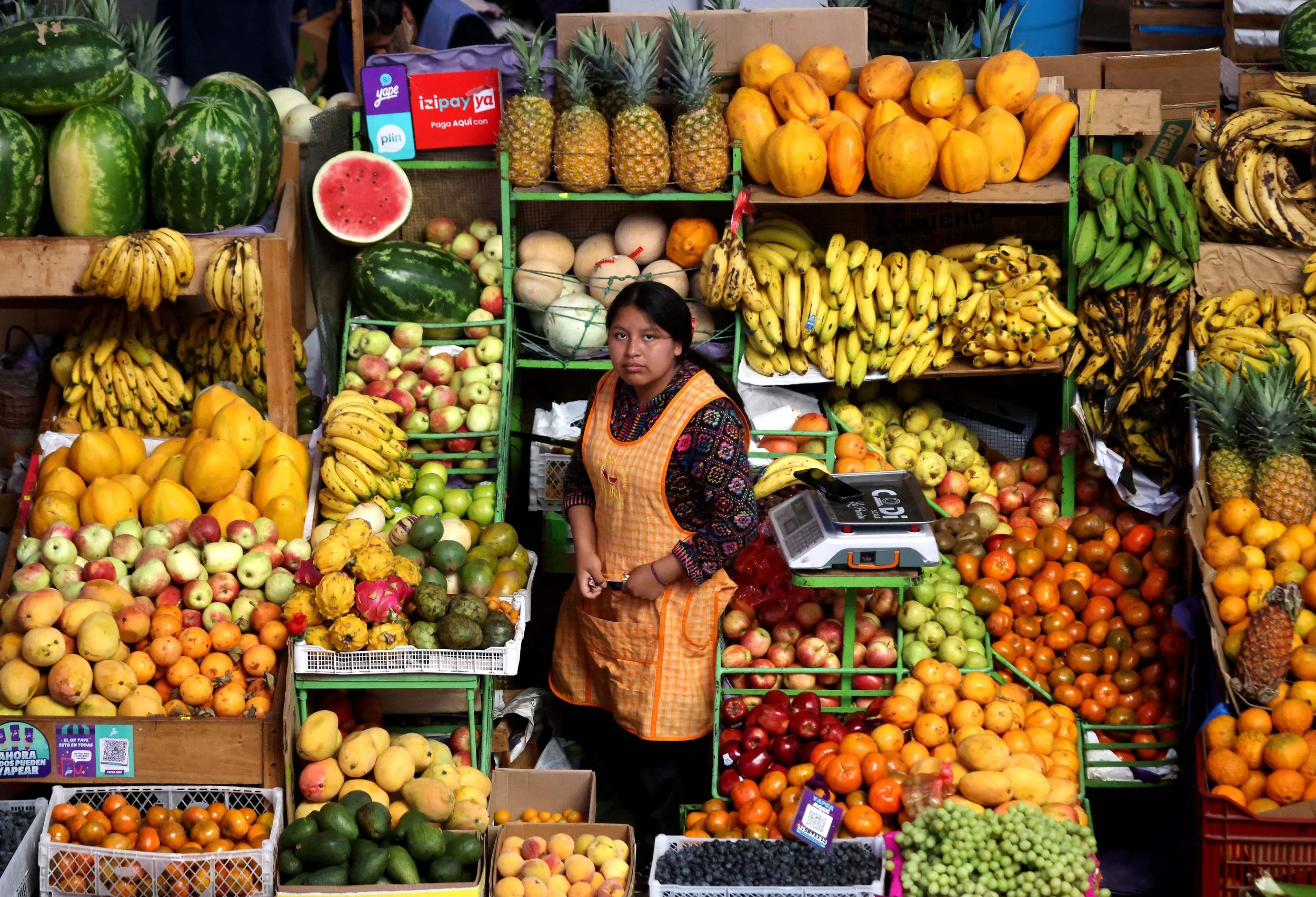 A market vendor works at the Mercado Antiguo Provincial de Urubamba, a huge, historic and wonderfully chaotic space that remains at the heart of everyday life in the Sacred Valley.