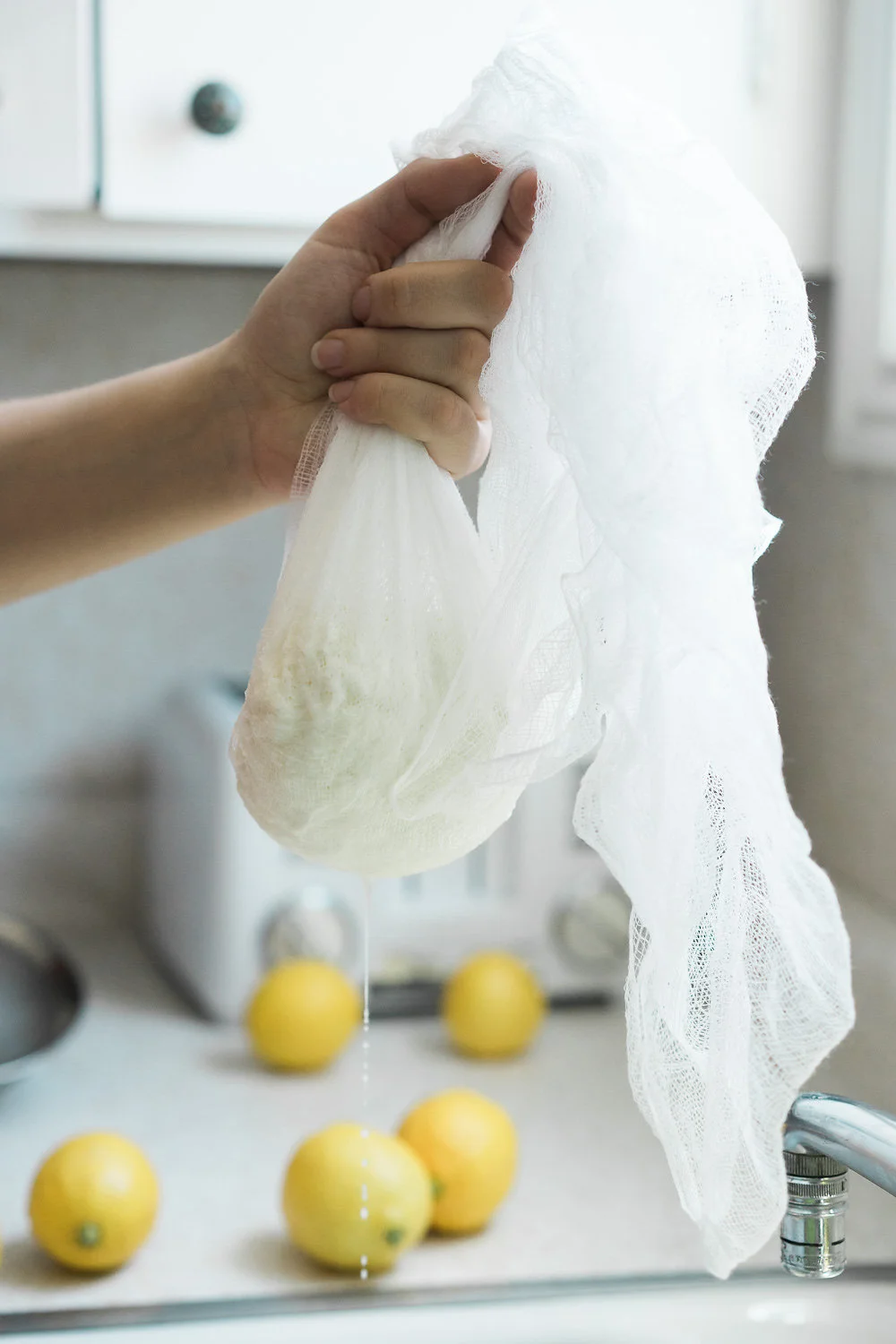 Paneer curds draining in cheesecloth – photo by Vero Kherian