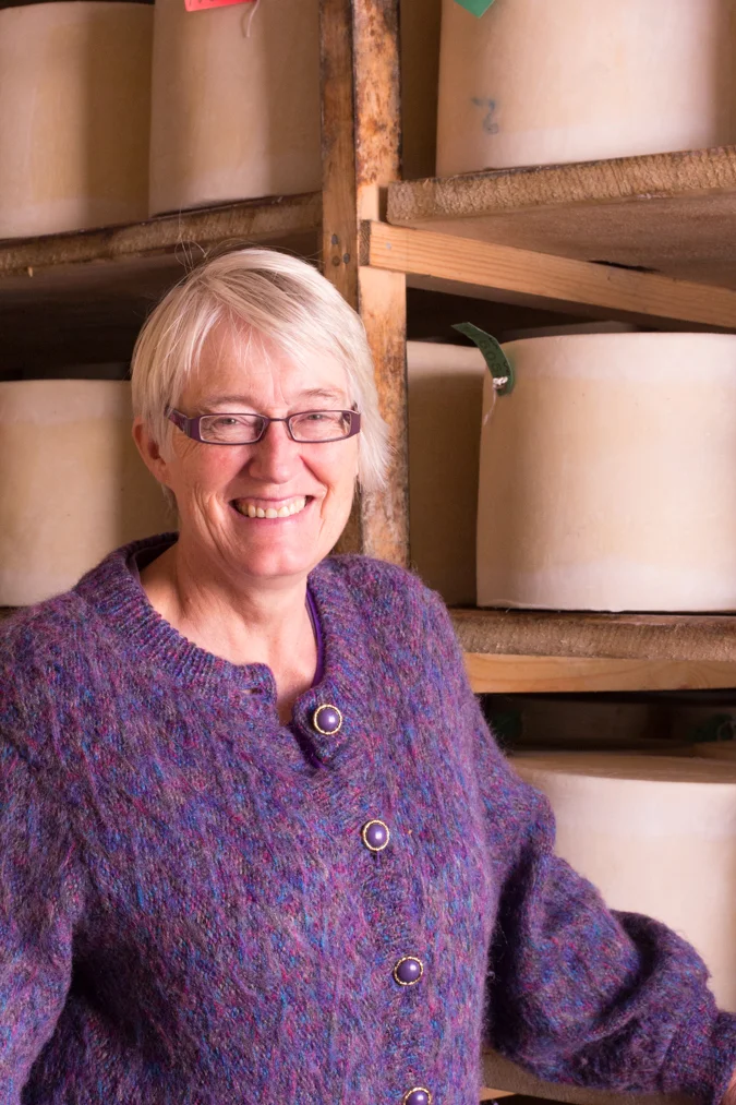 Mary of Quicke’s Cheese posing with her wheels