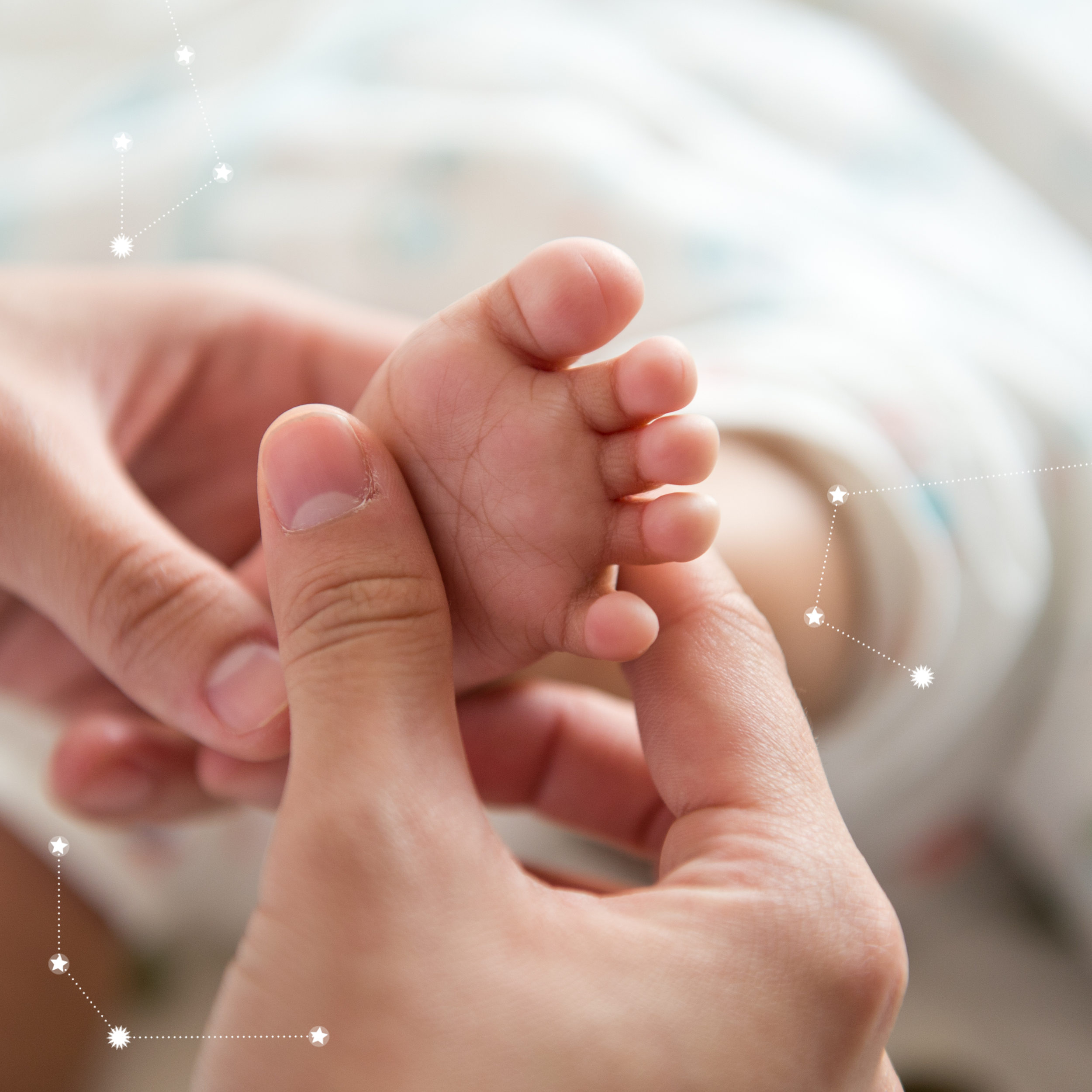 Close-up of a baby’s tiny foot being gently held by an adult hand, symbolizing nurturing care and infant health.
