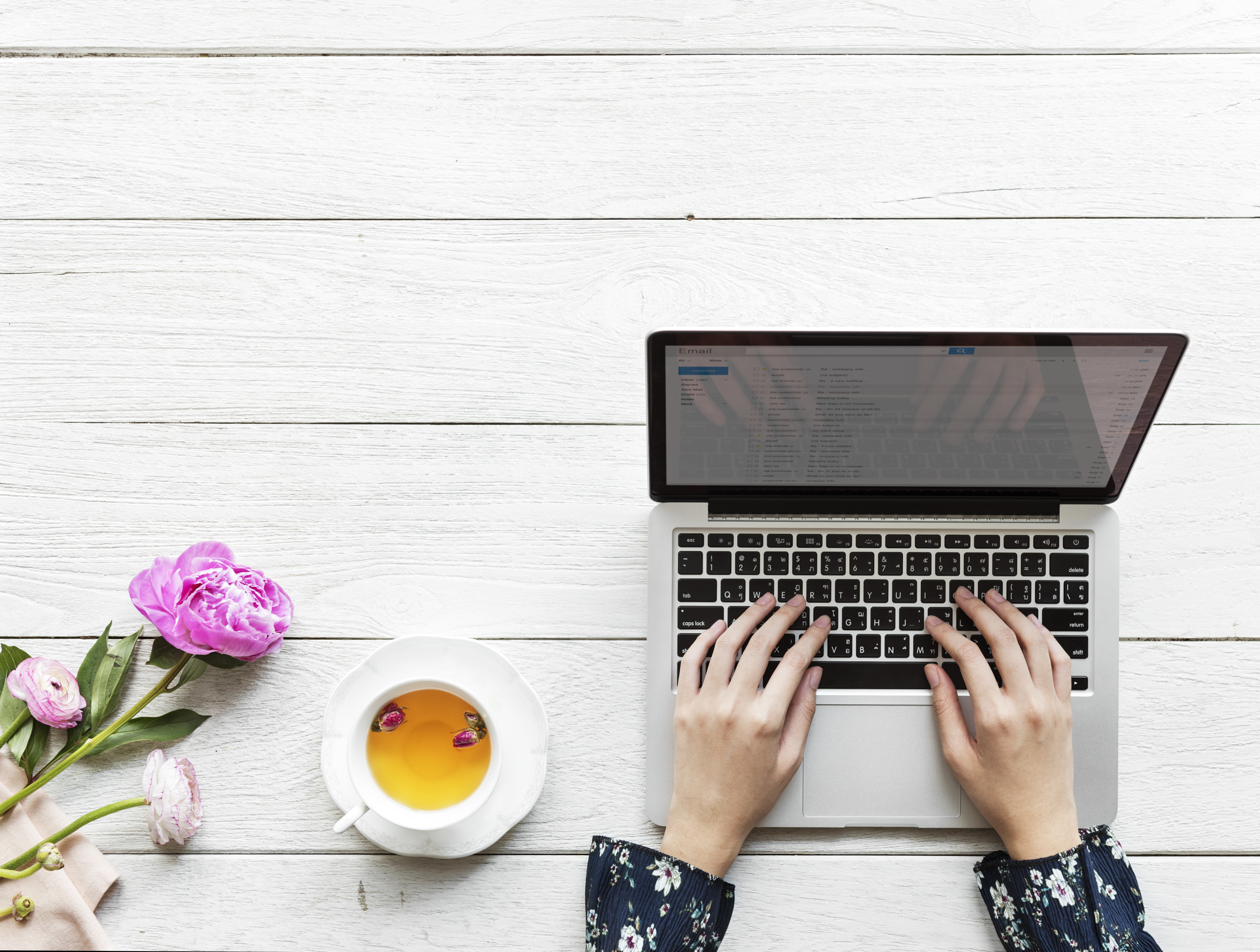 Aerial view of a woman using computer laptop working and hot tea