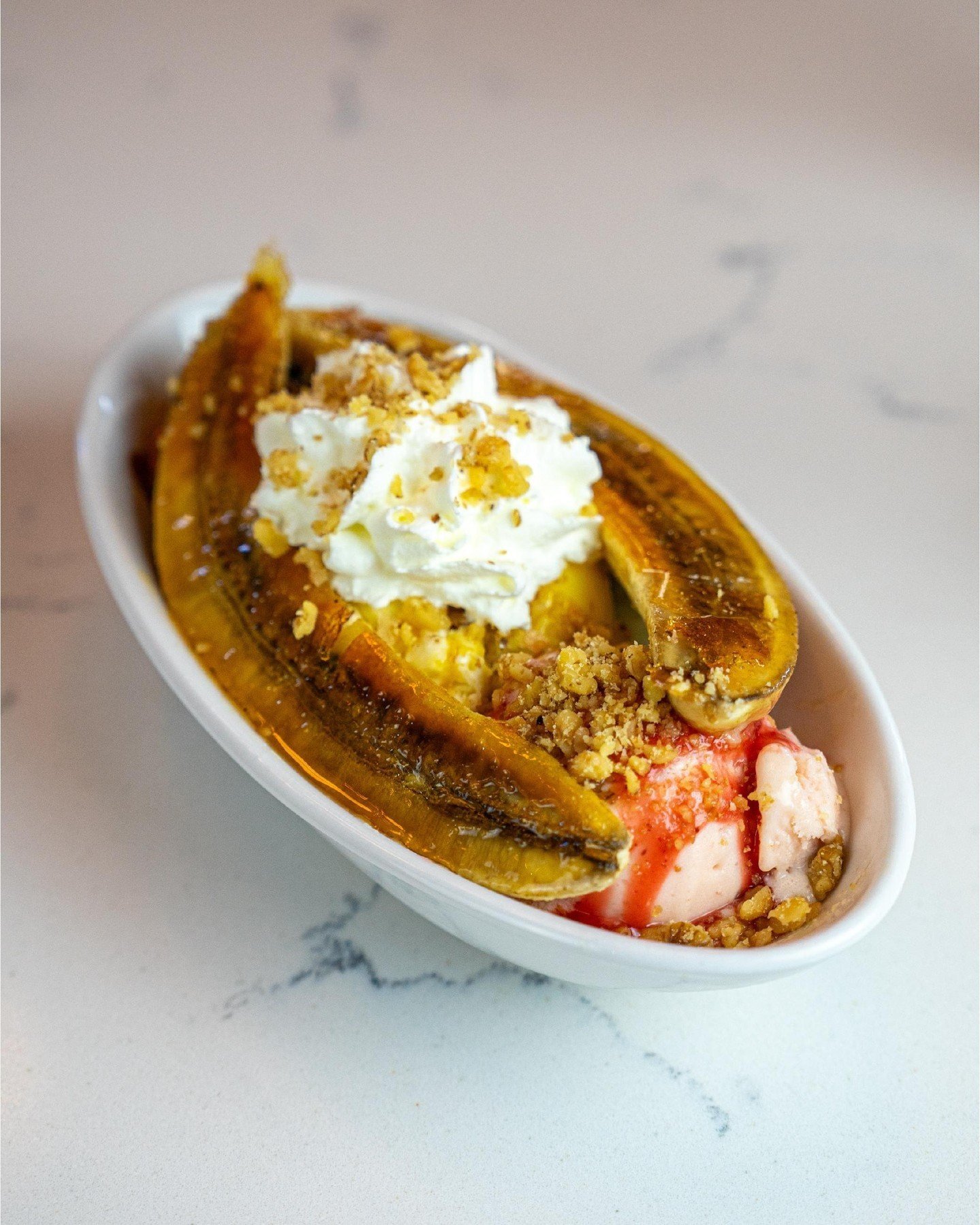 This weekend calls for a classic! 🍌

Come on in and try our banana split with chocolate, vanilla, &amp; strawberry ice cream, br&ucirc;l&eacute;e banana, whipped cream, and crushed peanuts! 

Open until 11pm tonight!