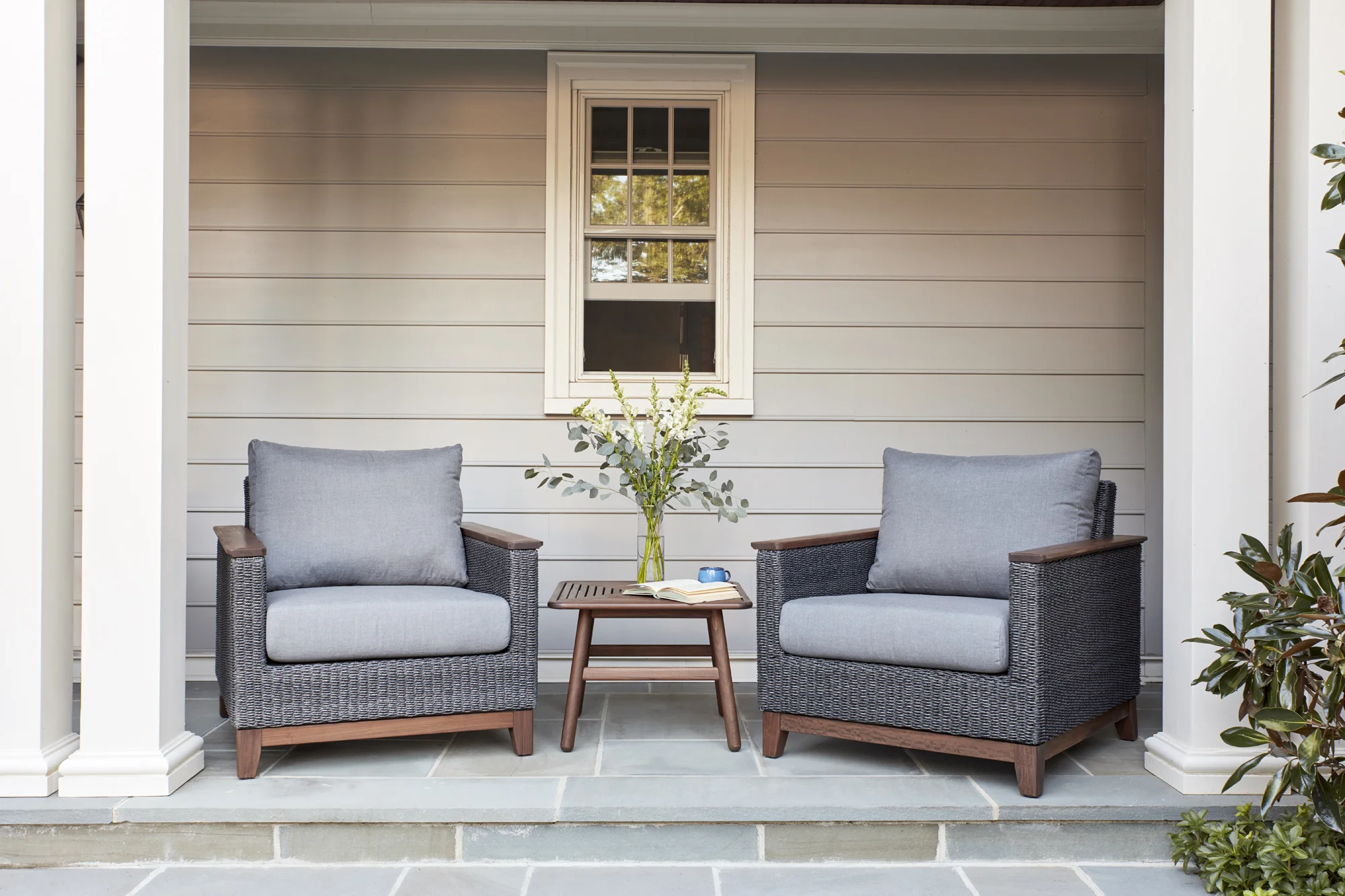 Coral cushion lounge chairs made with all weather resin wicker & Ipe wood frames and arms with Ipe wood slat side table. Cushions are made with weather & stain resistant fabric.
