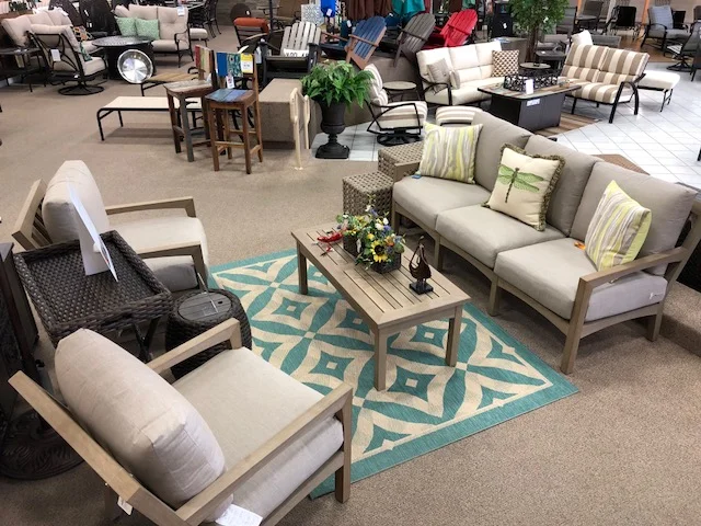 Realis-Teak colored throughout with appearance of natural teak wood. Water repellent, does not stain. Del Ray cushion Sofa, Del Ray rectangle coffee table, Del Ray cushion lounge chair and Del Ray cushion swivel rocker lounge chair.
