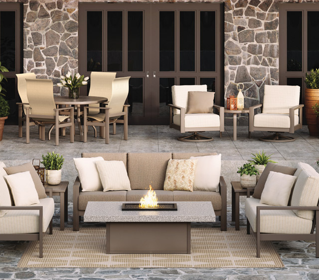 Homecrest Elements cushion aluminum frame collection sofa, loveseat & Lounge chair with rectangle firepit. Two Elements cushion swivel lounge chairs with side table. Four Elements sling dining chairs with round dining table.