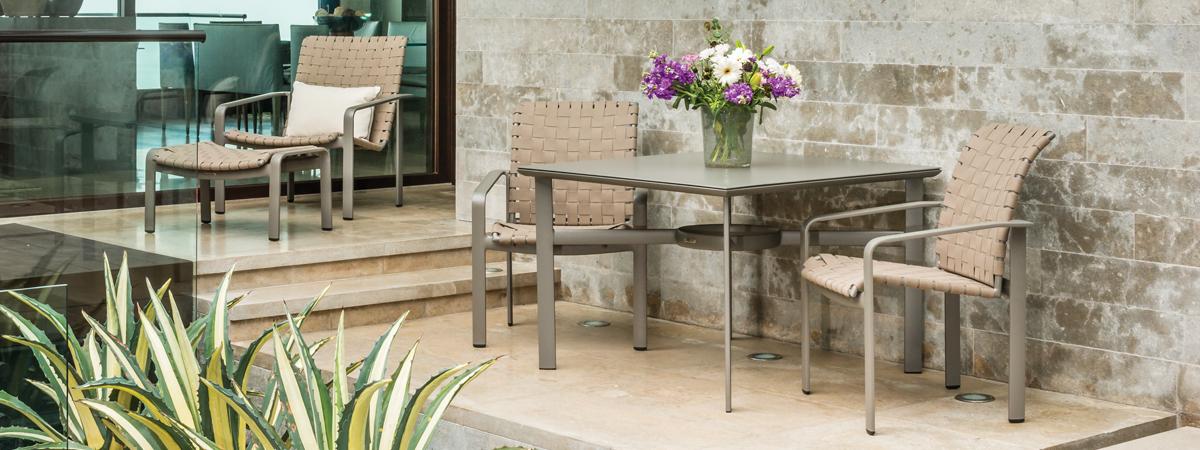 Softscape Strap motion chair and ottoman and Softscape strap dining chairs.