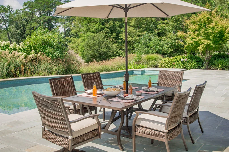 Trenton Dining Collection - Chairs constructed of resin wicker & powder coated aluminum with seat cushion. Extension Table is powder coated aluminum 40” x 83”.