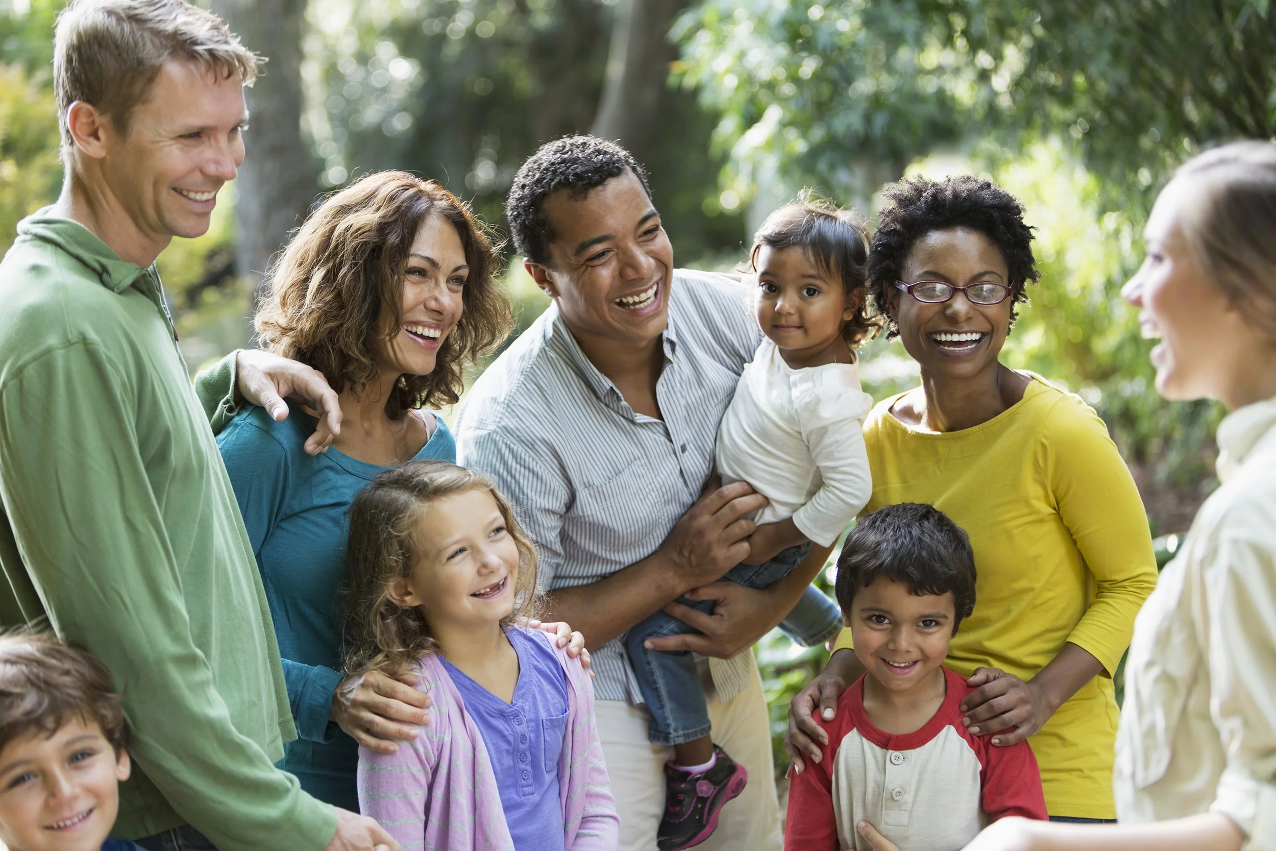 A group of families shares a memory in the beauty of a natural setting.