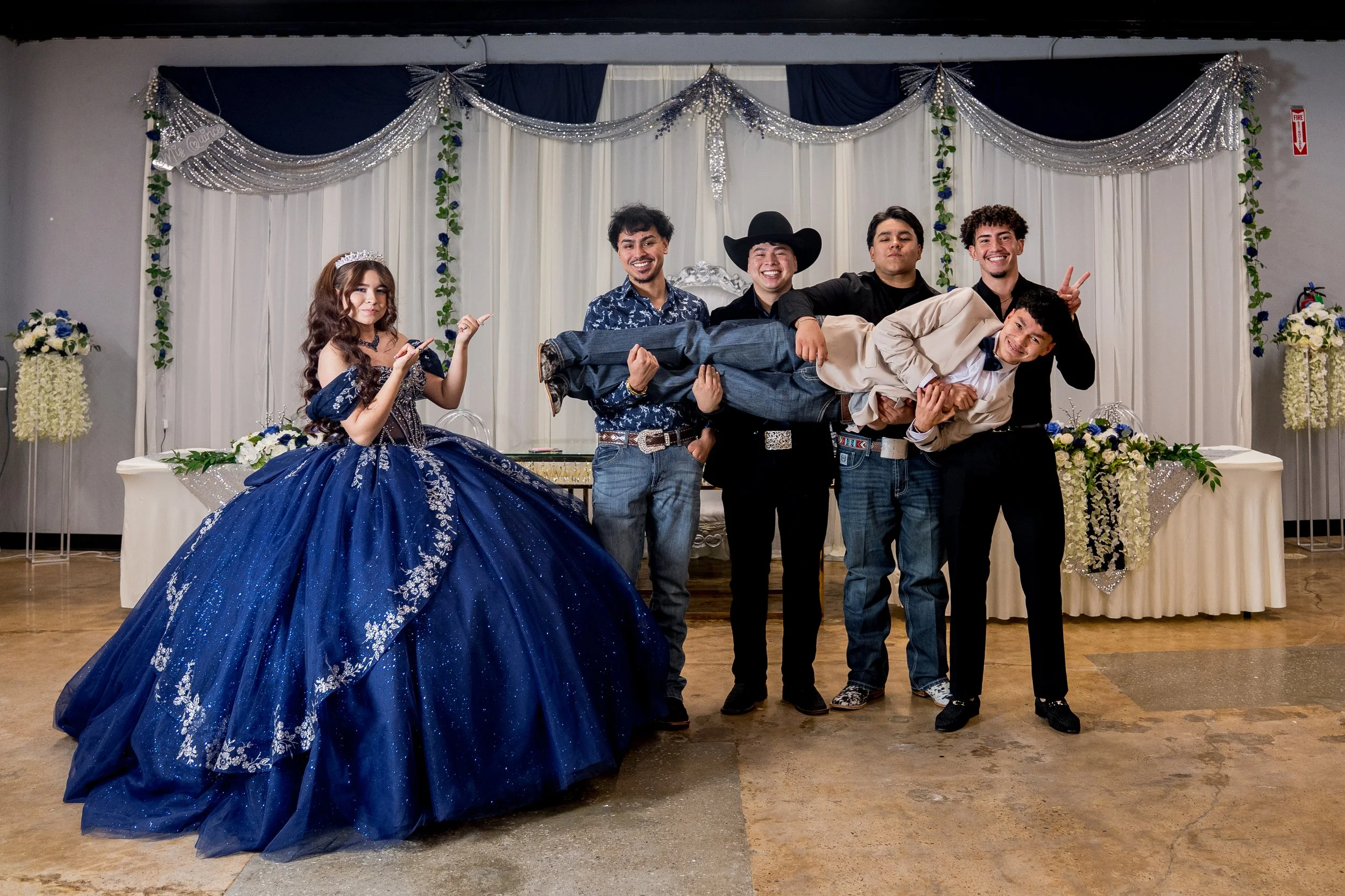 Miss XV wearing a blue dress for a quince. Quince Chambelanes compliment the photos very nicely. They work elegant tuxedos.