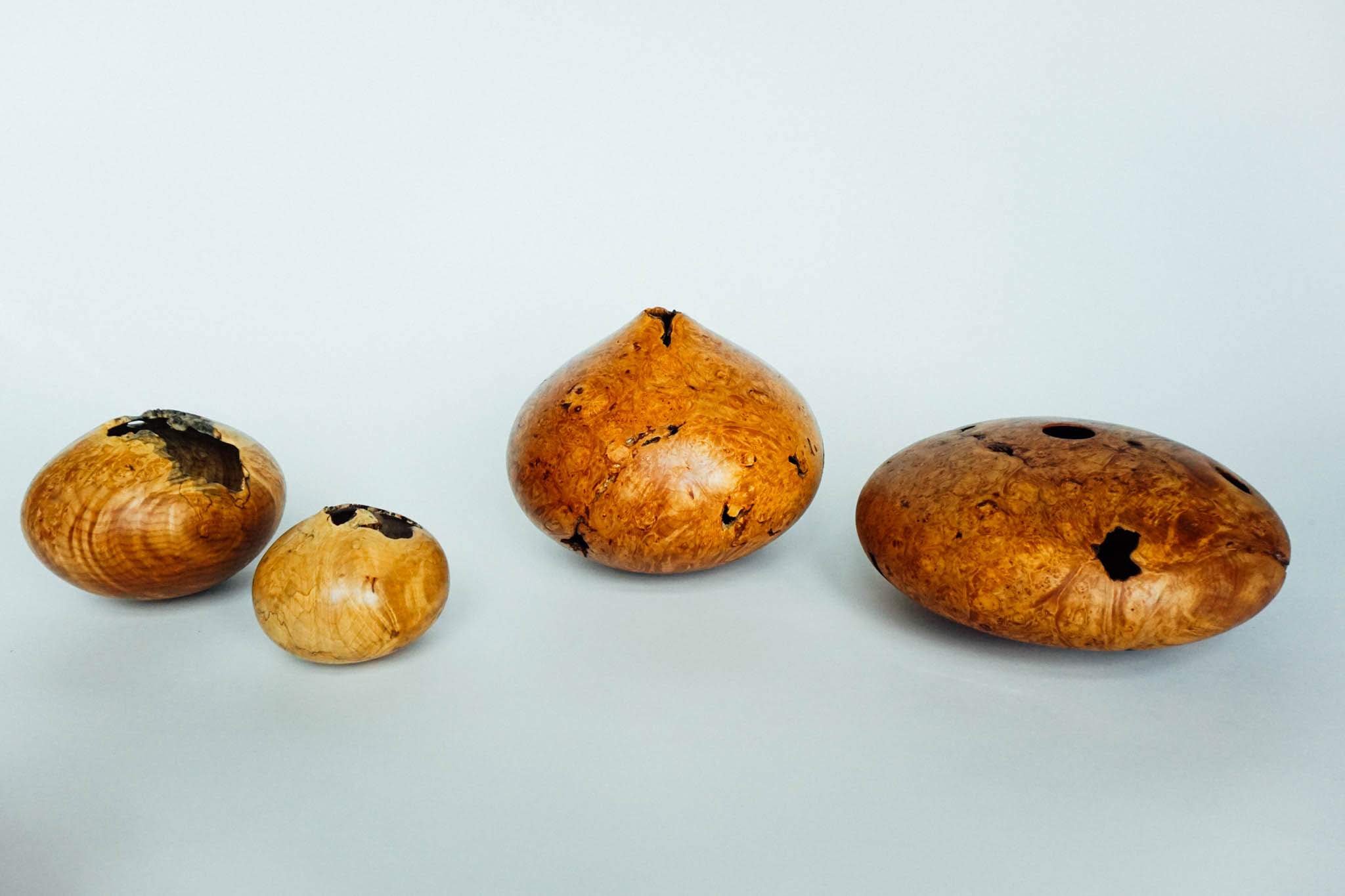 An arrangement of hollow forms in maple burl.