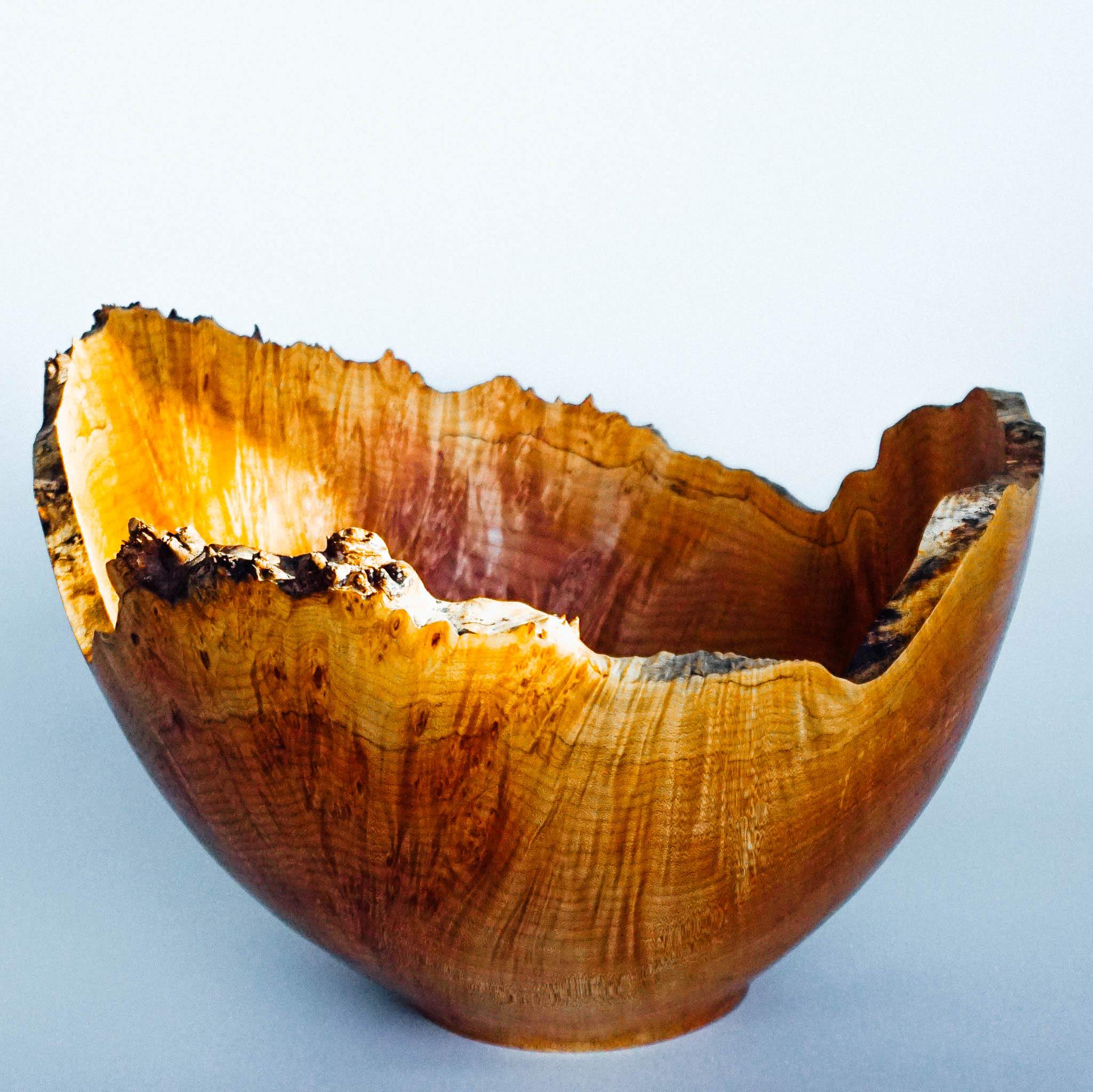 This large natural edge maple burl bowl is a great display piece. It is approximately 15” in diameter and 12” tall.