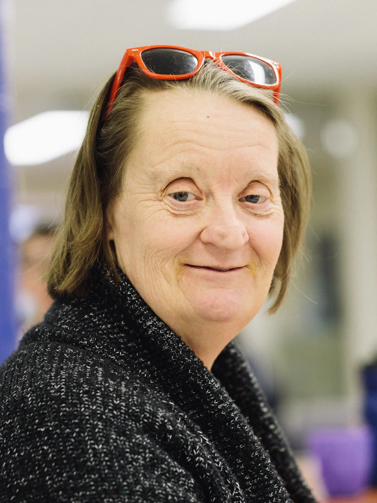 Picture of lady smiling with sunglasses on her head