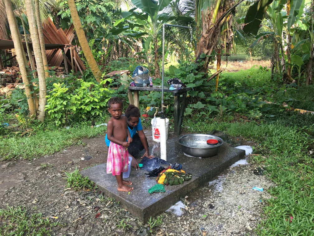 This multitasking mum is washing clothes, dishes and her son!  A clothes and dish rack would be the perfect improvement.