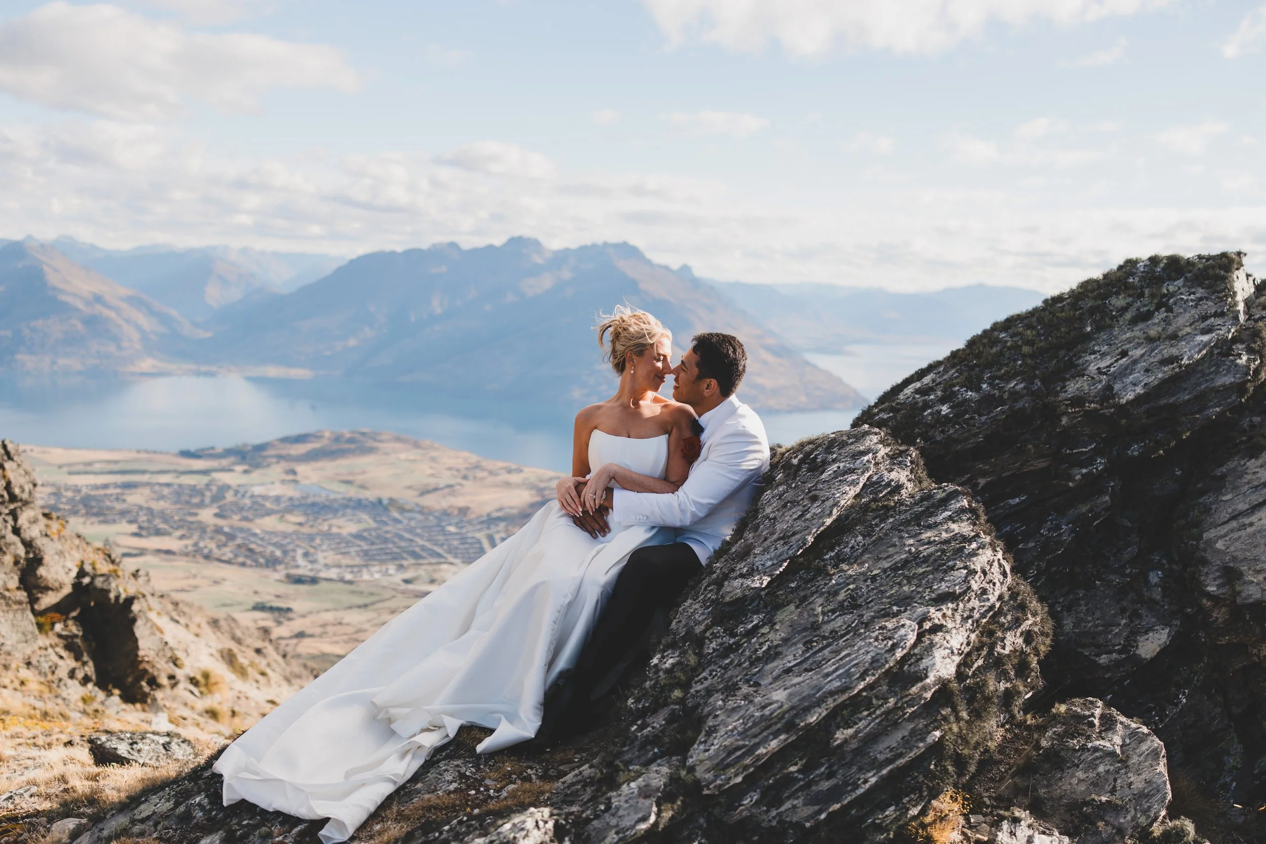 Hannah and Brad captured at the top of a mountain in Queenstown, New Zealand wearing Dahlia in mikado by Alena leena.