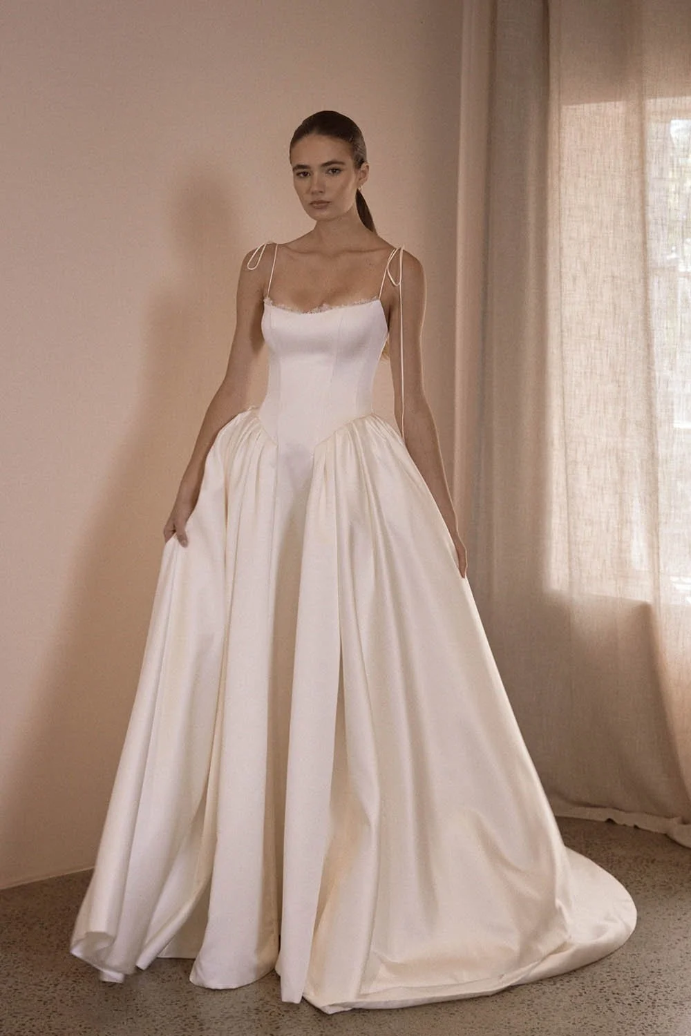Alba by Vagabond Bridal featuring ivory satin ballgown silhouette and scoop neckline with Chantilly lace trim available exclusively at The Art of Bridal, Brisbane bridal boutique Queensland.