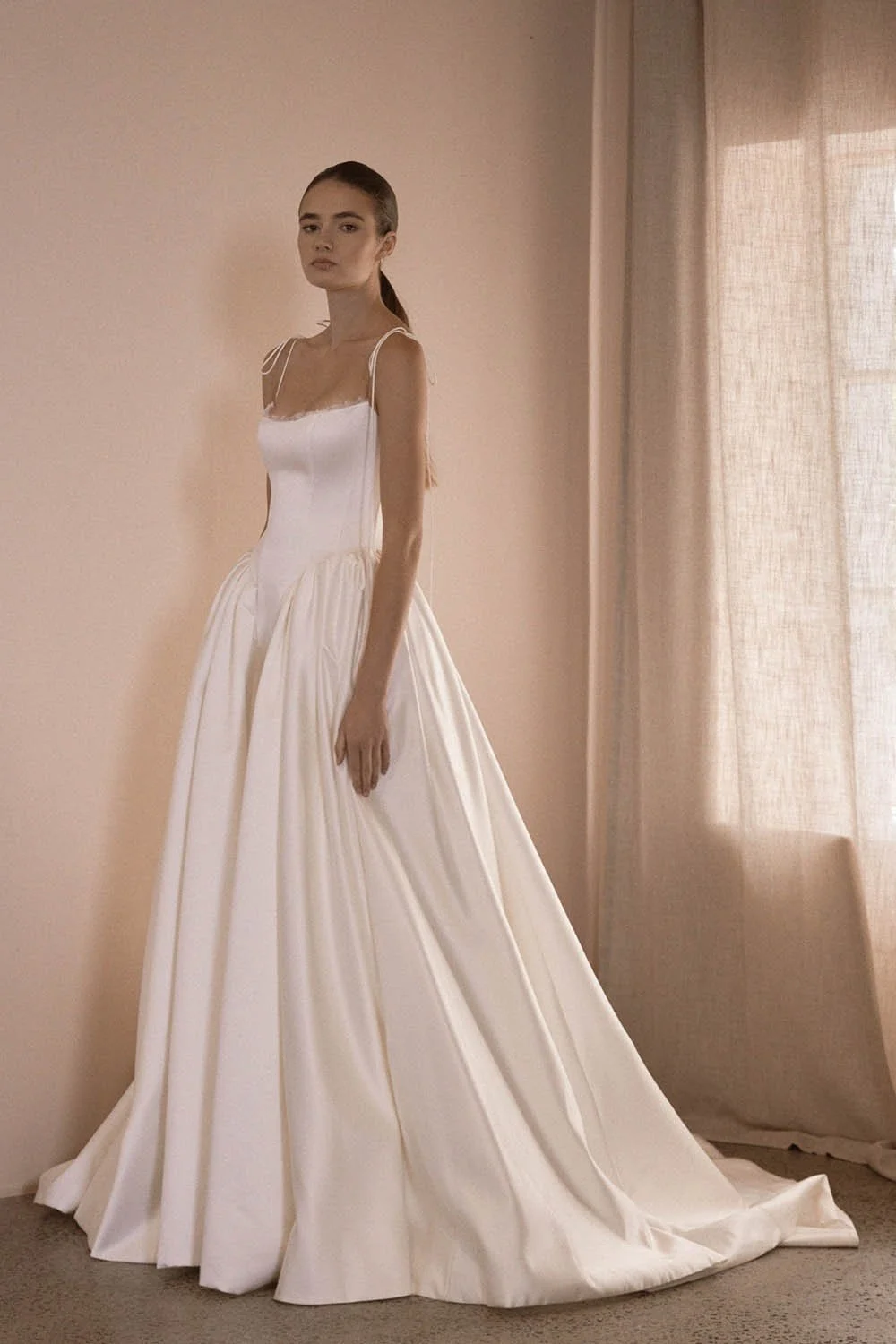 Alba by Vagabond Bridal featuring ivory satin ballgown silhouette and scoop neckline with Chantilly lace trim available exclusively at The Art of Bridal, Brisbane bridal boutique Queensland.