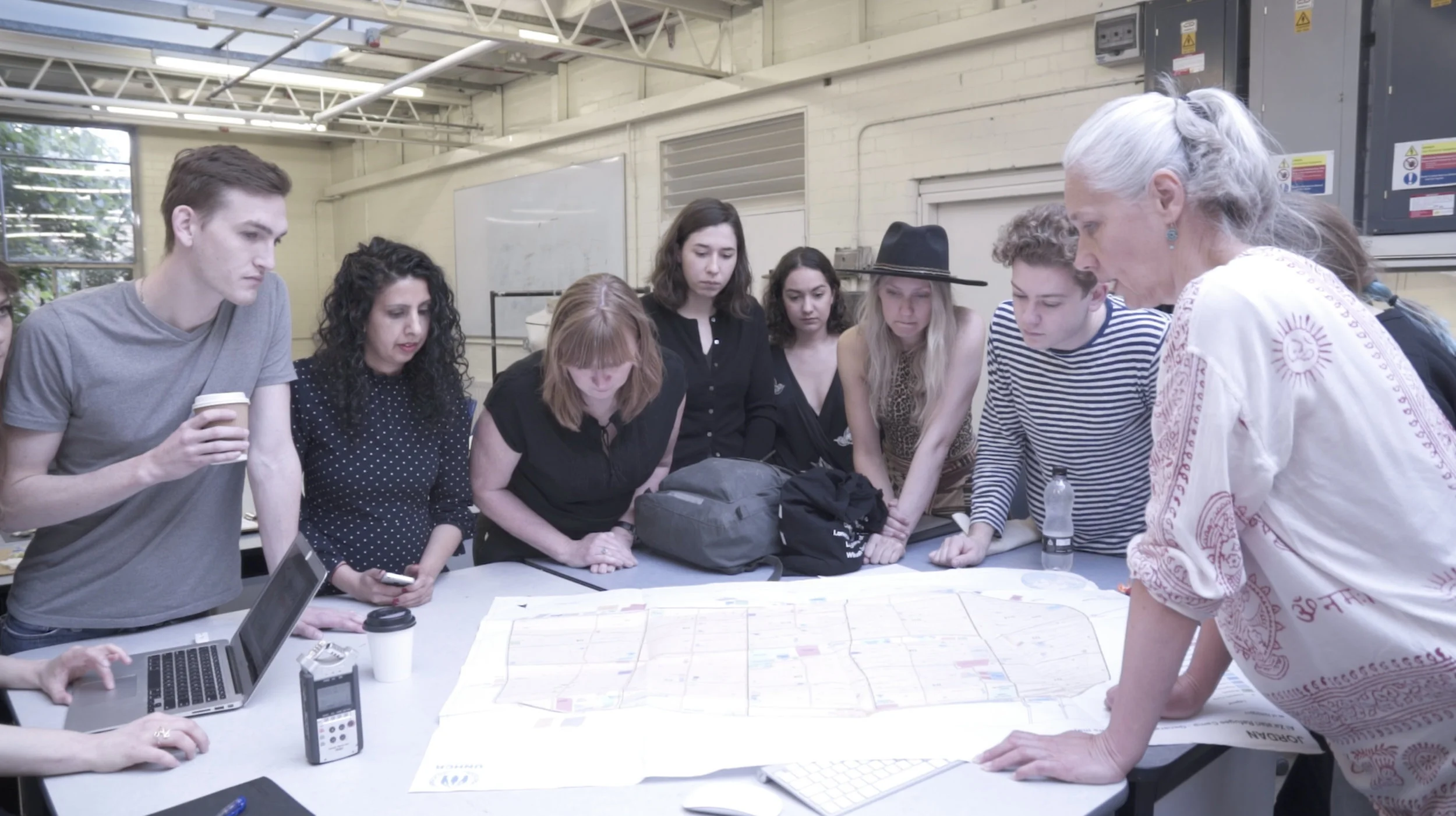  MA Fash/Futures students looking at the map of Za'atari 