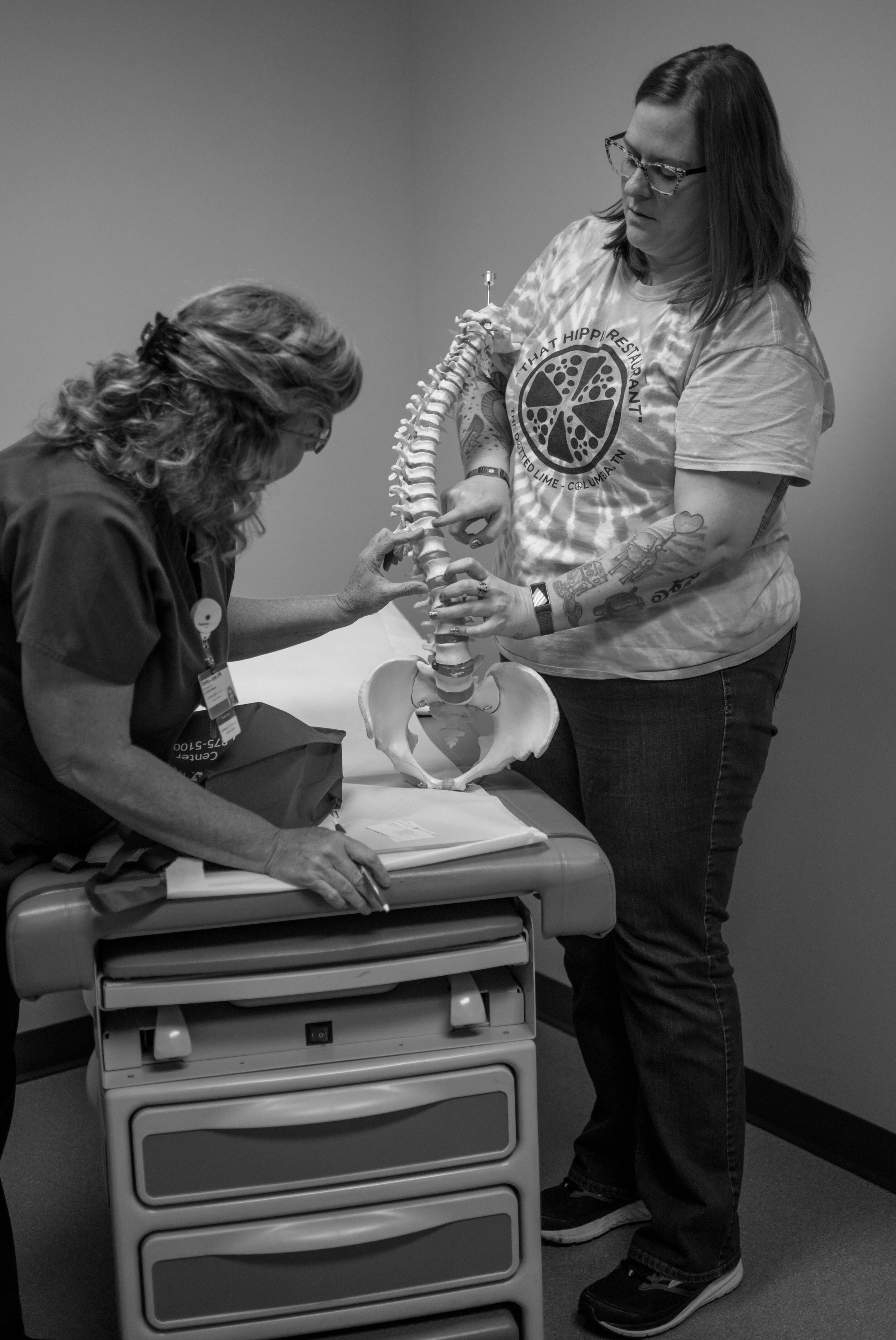 Me showing Nathan the part of my spine they'll be working on