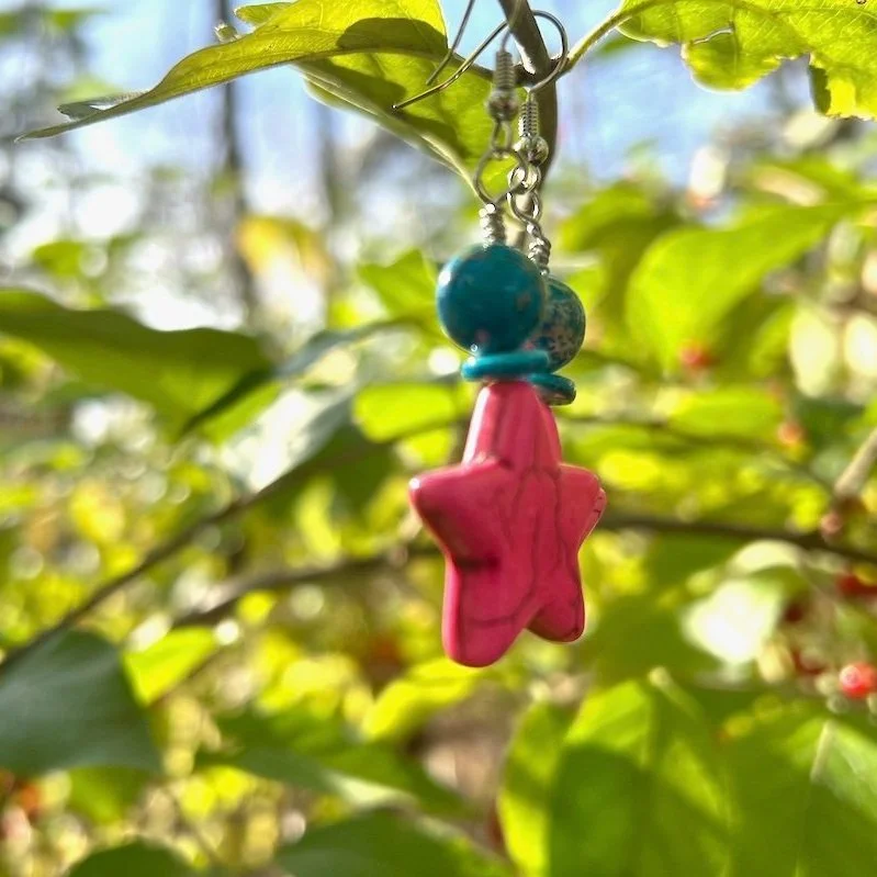 Beaded earrings with a pink star stone bead, topped with a blue crystal