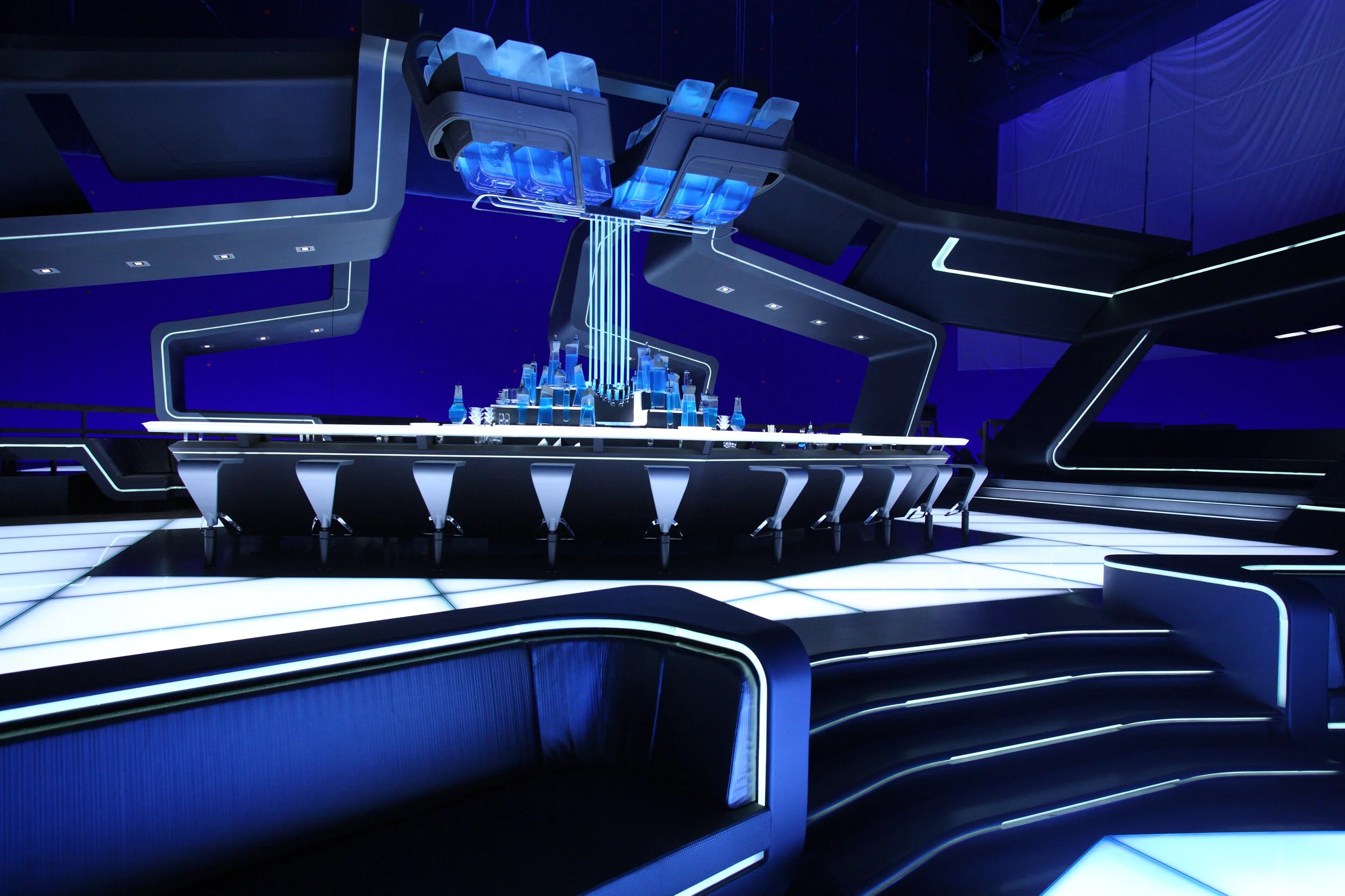  Again lighting of the sets created needs in infrastructure.  Set had to be built on risers. Lenses in the floor had to support the weight of the camera and shooting crew. A big challenge was to sync the lighting from panel to panel. For construction