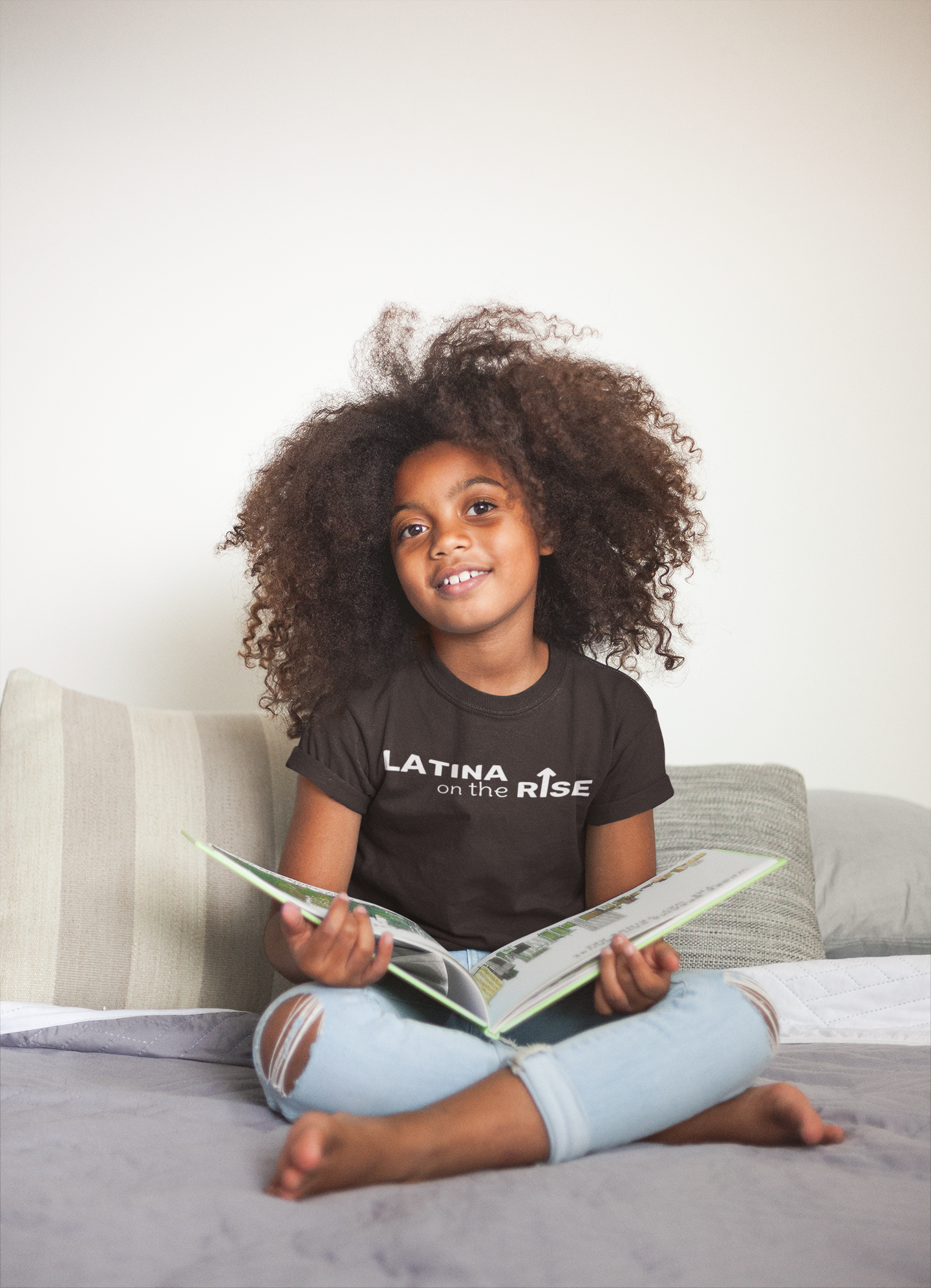 mockup-of-a-little-black-girl-wearing-a-t-shirt-while-reading-a21320.png