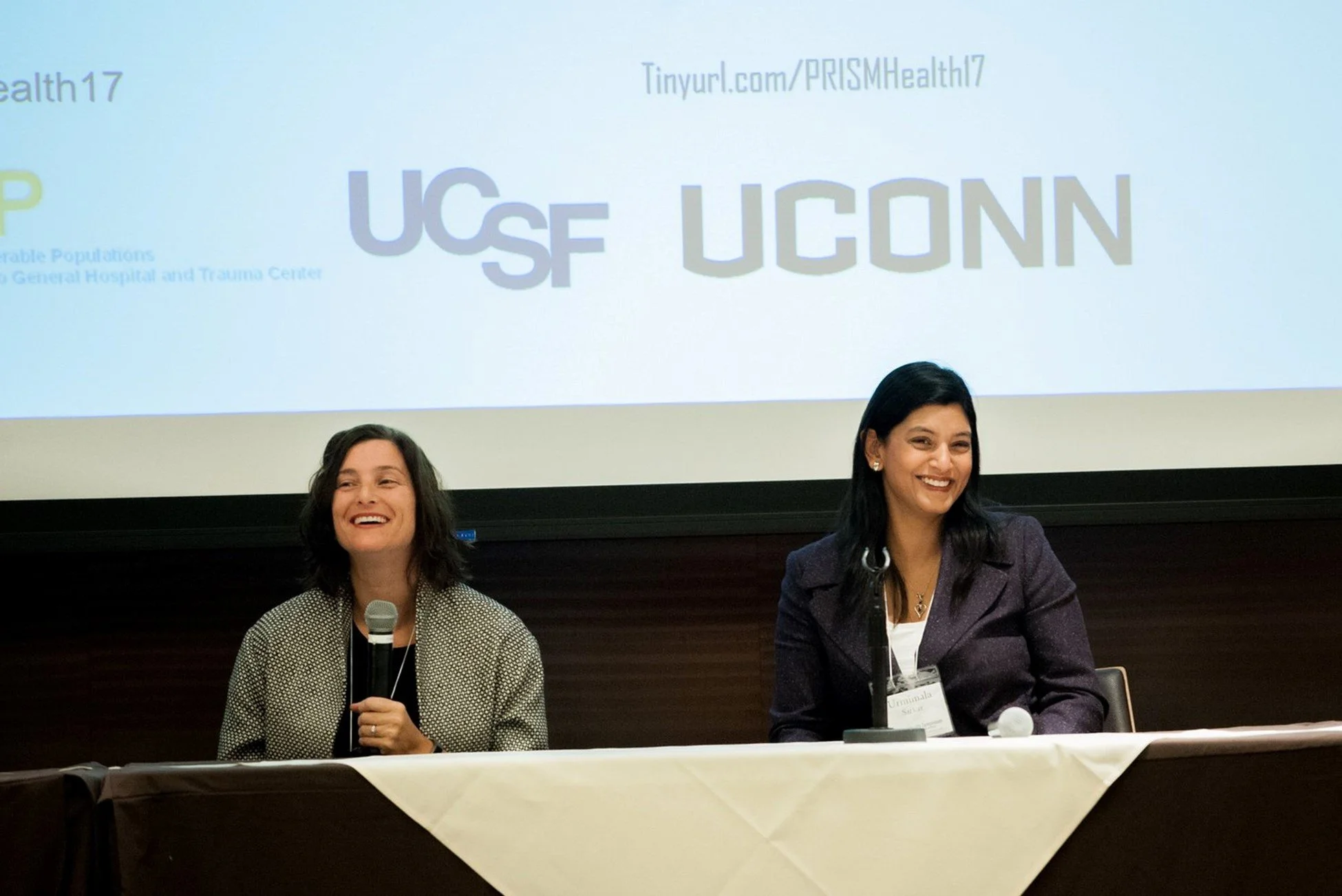 Women sitting at table with mircophones.jpg