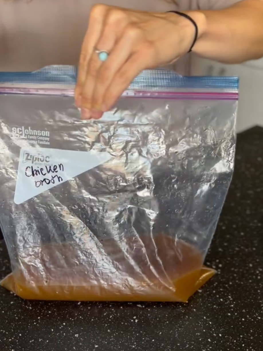 hands closing a ziploc bag with liquid in the bottom