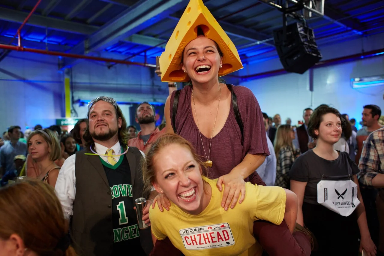  Rachael Faulds and Jen Roit cheer on competitors in the final cheese-themed contest pairing cheese and beer.  STEVE REMICH FOR THE WALL STREET JOURNAL 
