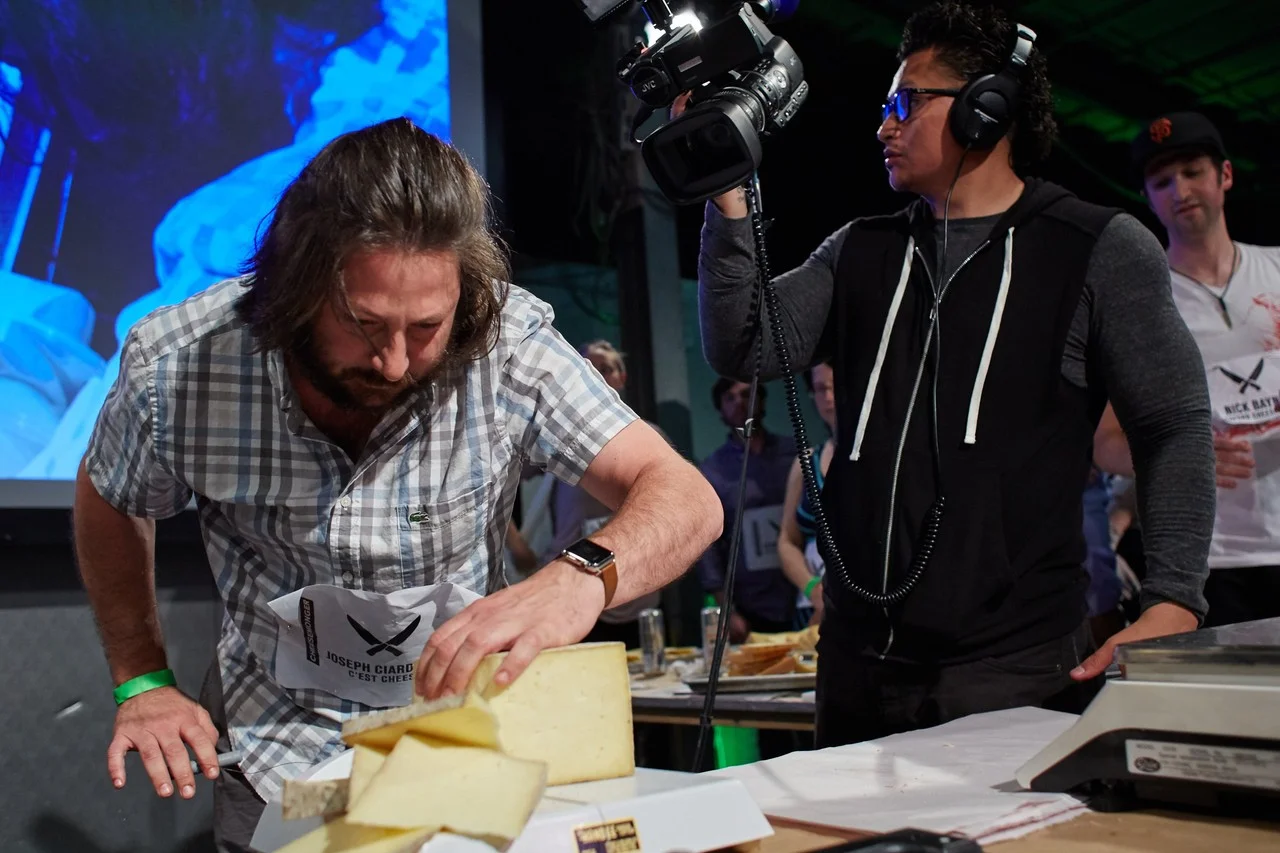 Joseph Ciardullo of C'est Cheese tries to cut a block of cheese into exactly one-third pound sections. STEVE REMICH FOR THE WALL STREET JOURNAL