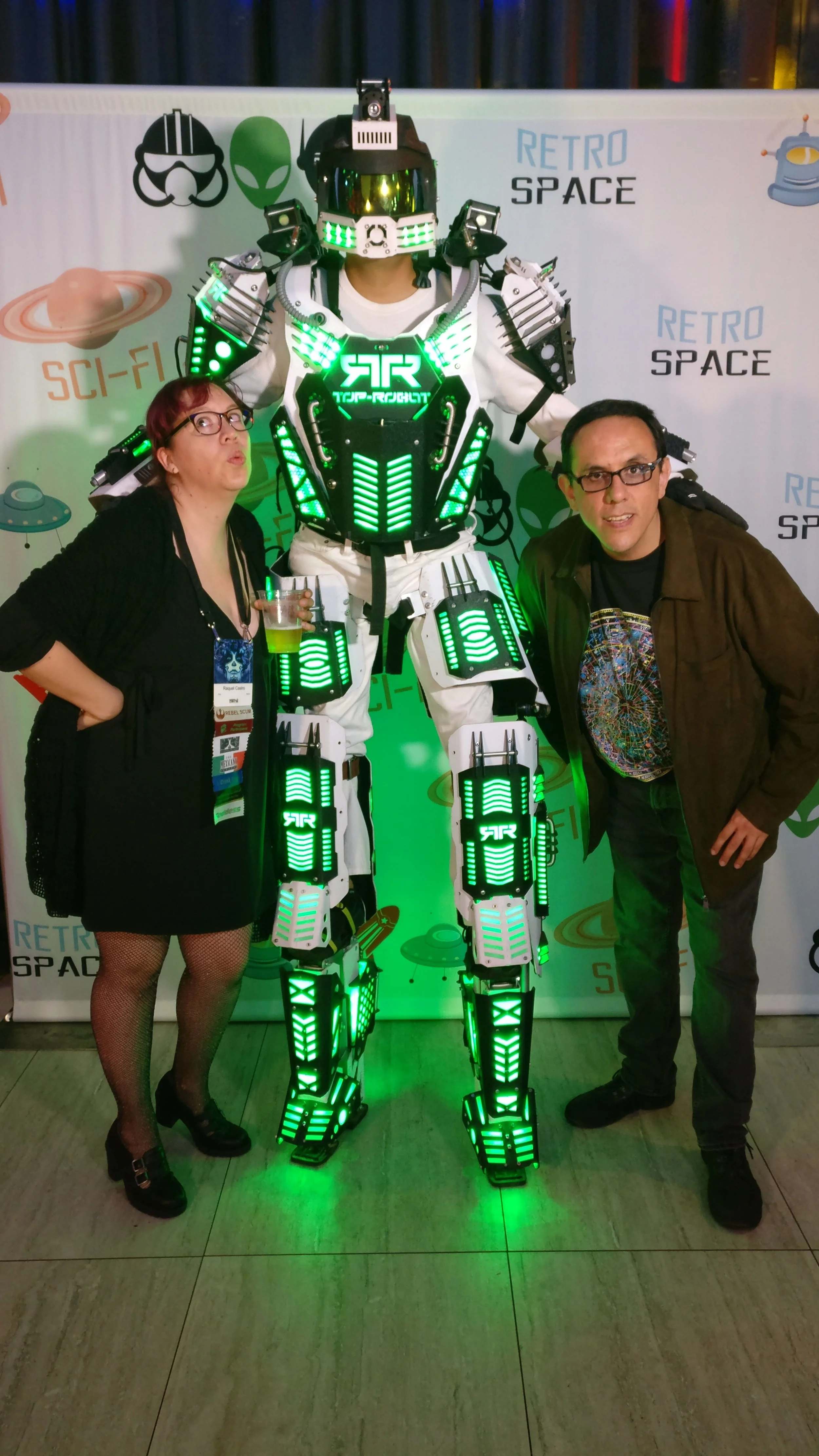 Raquel Castro and Alberto Chimal with a giant robot at the Hugo Losers Party