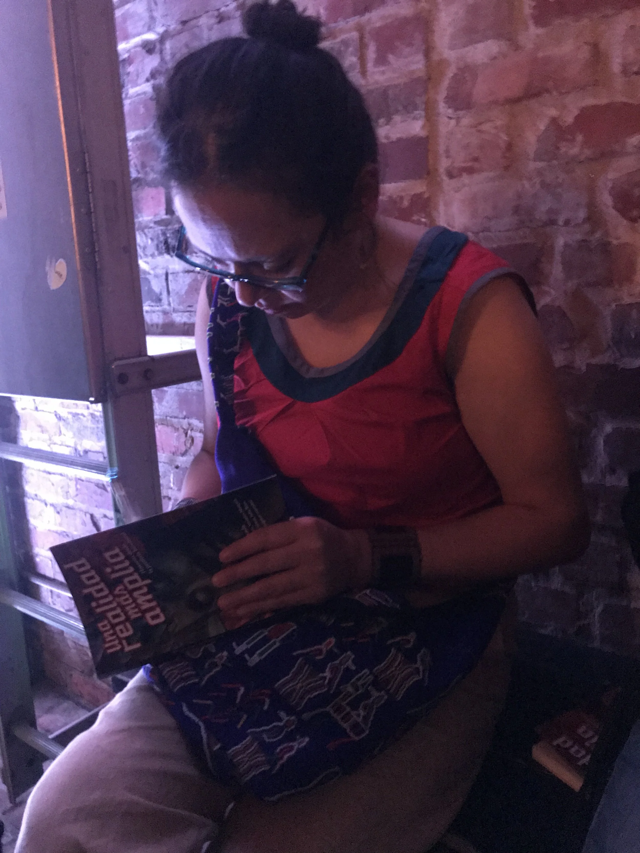 Libia Brenda holding a copy of the anthology she edited (Photo by Julia Rios)