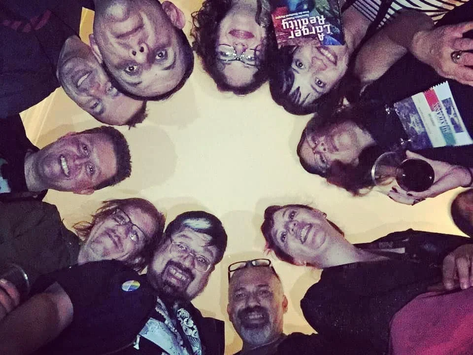 A selfie from below of a circle of Mexicanx Initiative participants huddled together at the Mexicanx Initiative Reception (Photo by Alberto Chimal)