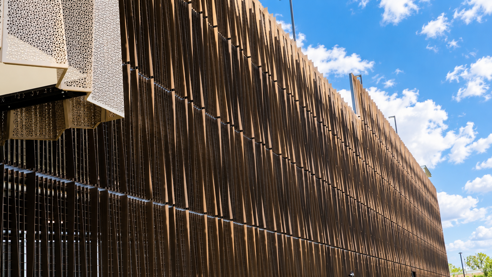 Modern Bronze Louvered Facade Under Blue Skies.png