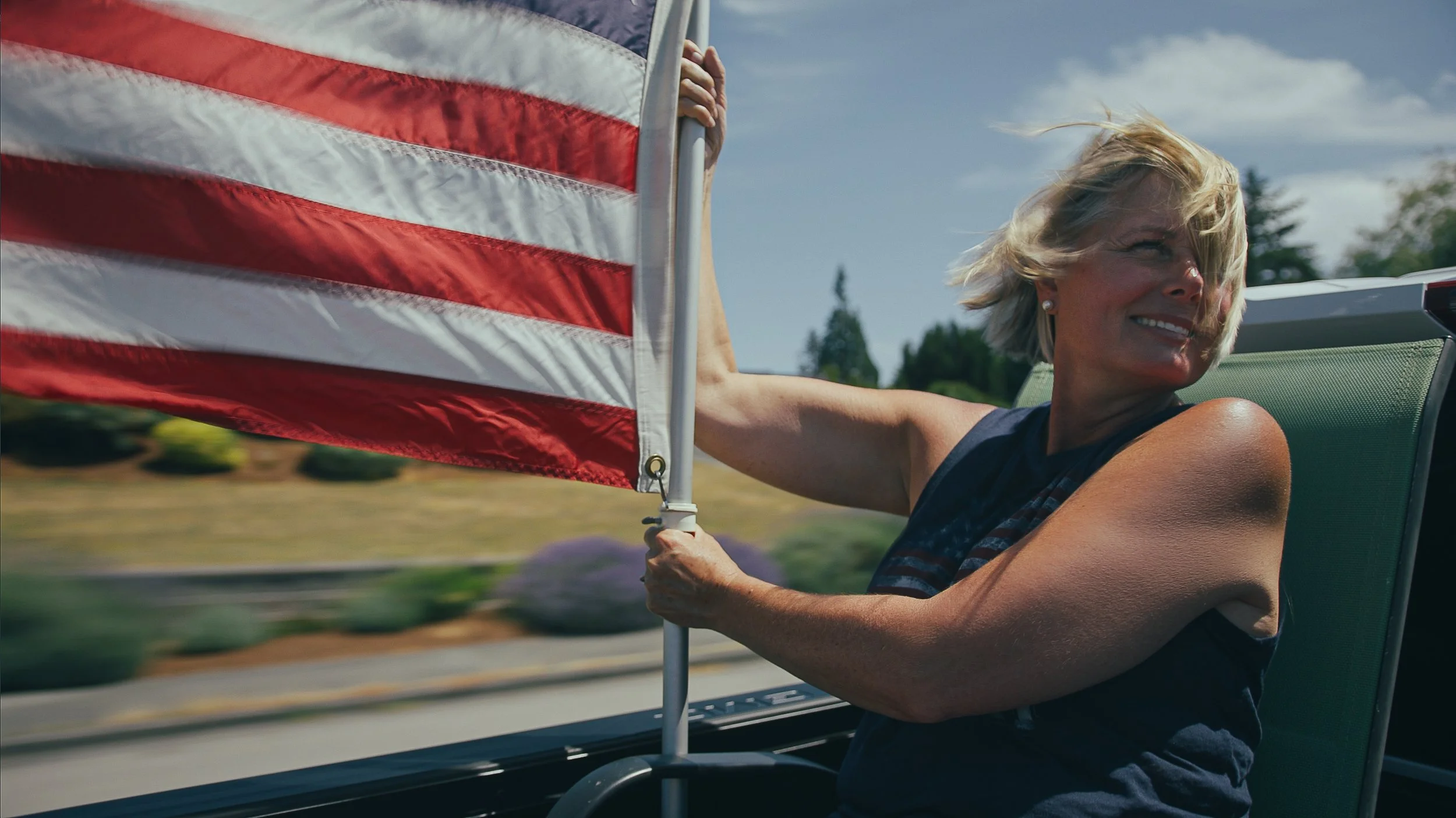 Julie with Flag at Freedom Parade_still 1.jpg