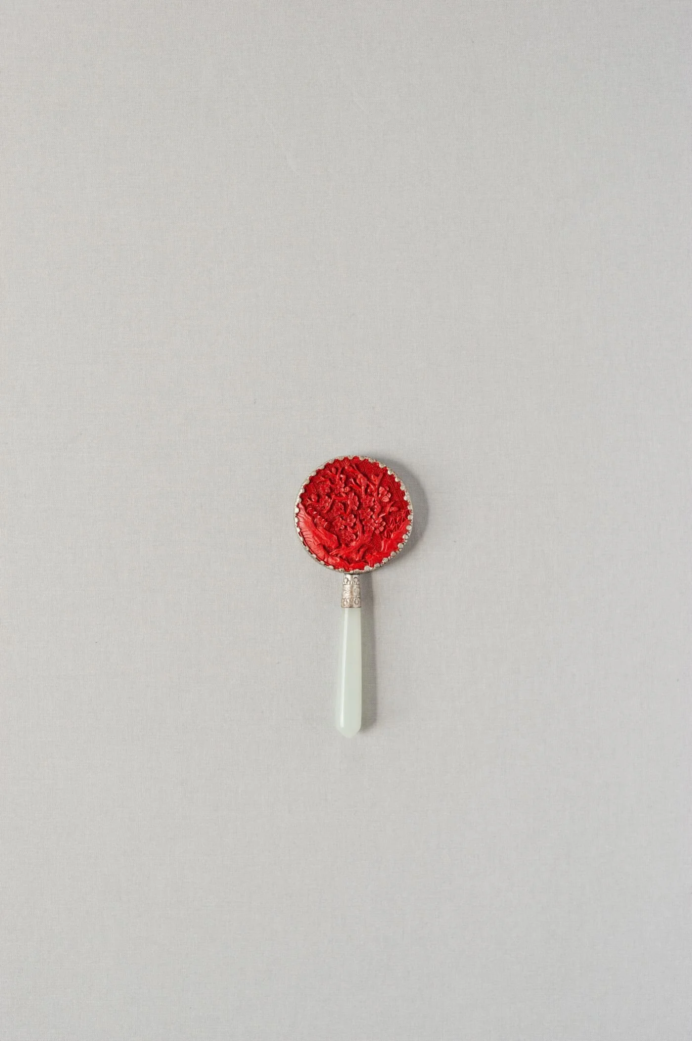 small carved, jade handled mirror 