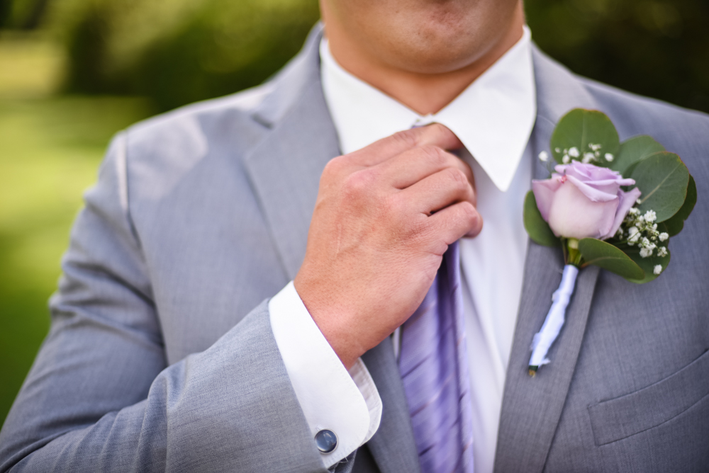 groom adjusting tie wedding photography
