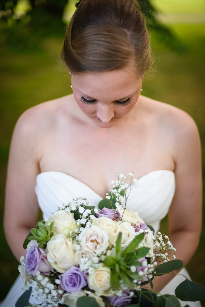 bridal photography, bride looking down at wedding bouquet
