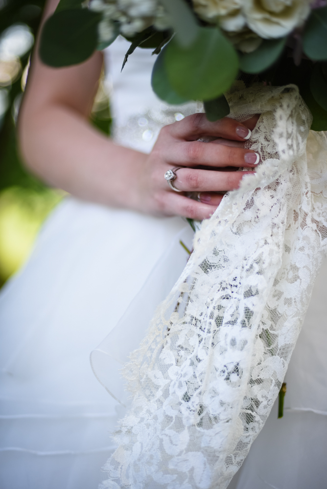 detail wedding photography bride holding wedding bouquet with lace