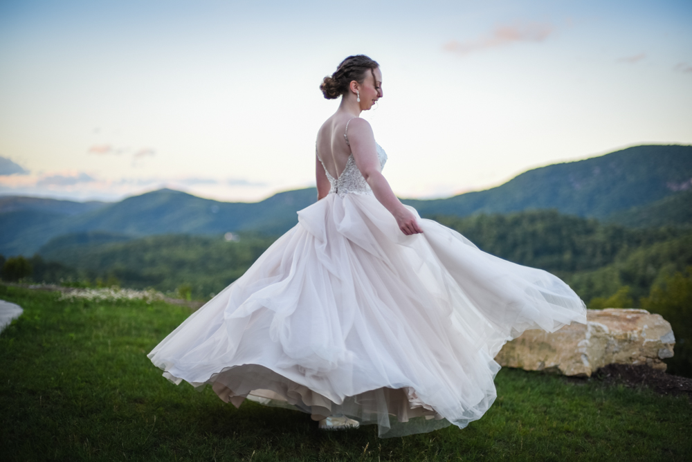bride twirling while overlooking the north carolina mountains at sunset
