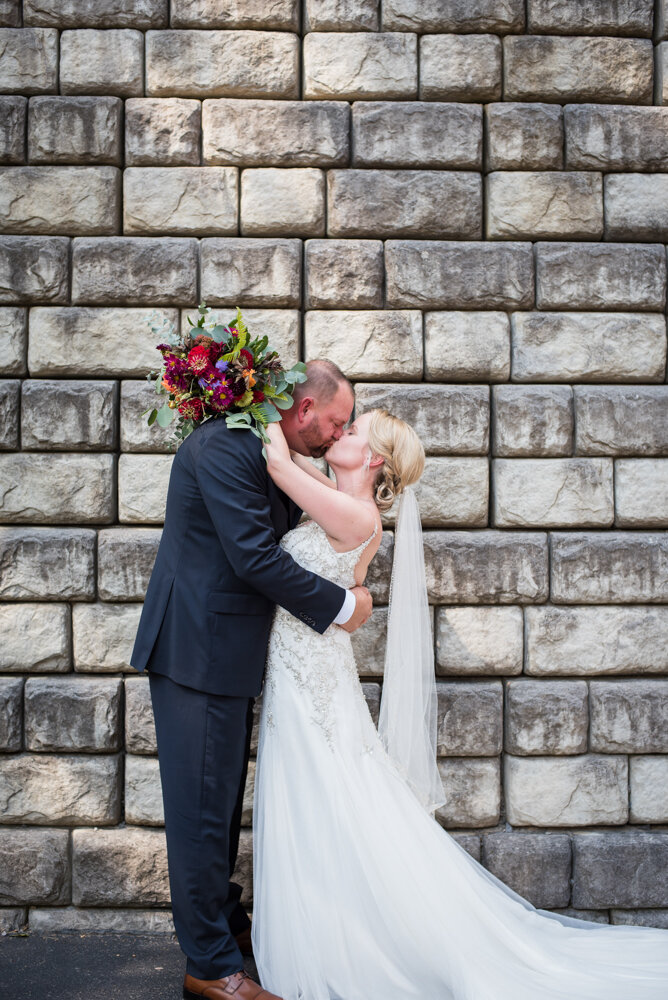 Gatlinburg mountain wedding bride and groom kissing in front of a rock wall