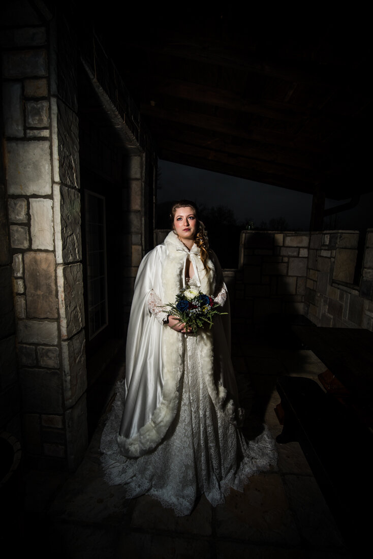 Bride holding flowers in castle doorway