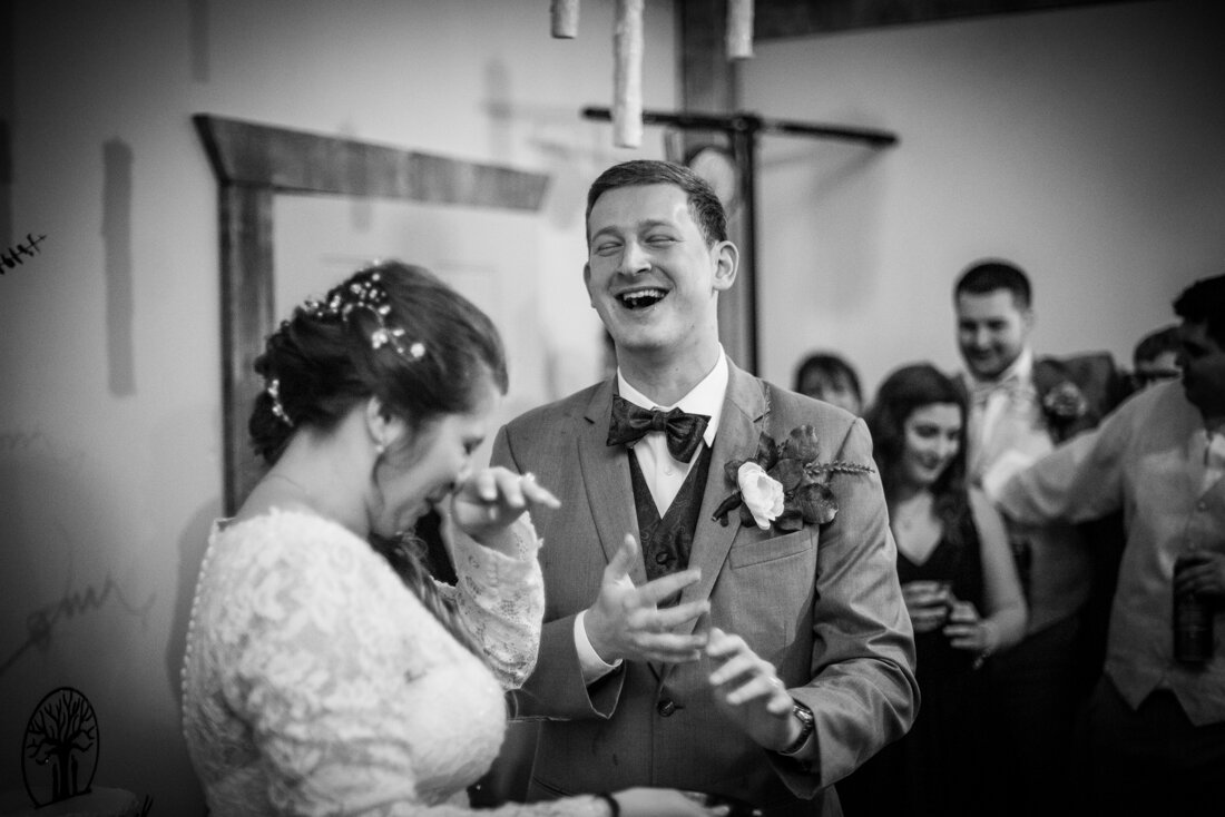 Bride and groom laughing together at wedding reception